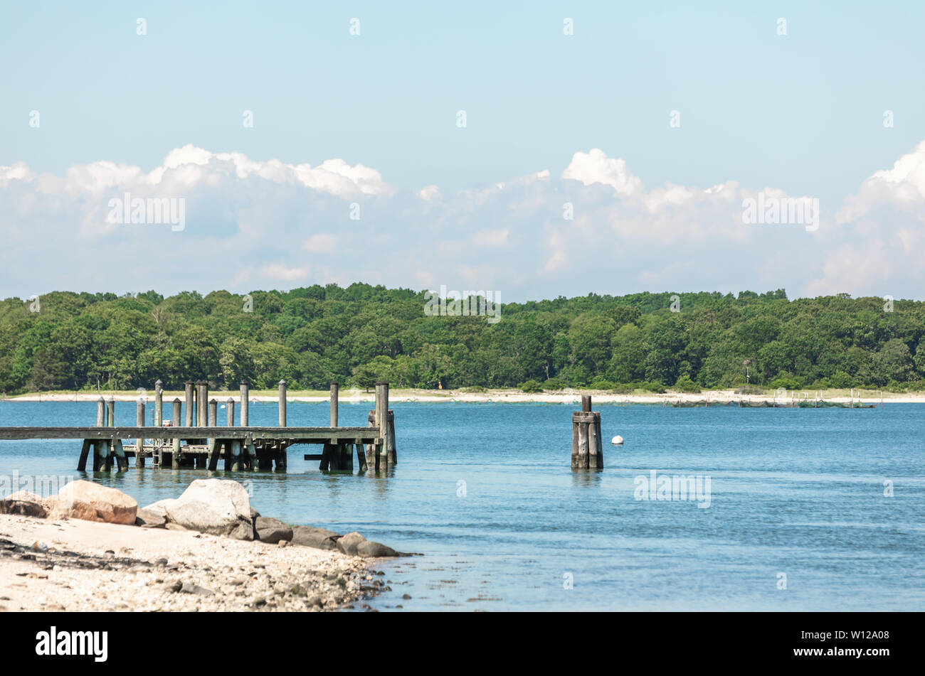 Landscape with water, a dock and land in Shelter Island, NY Stock Photo