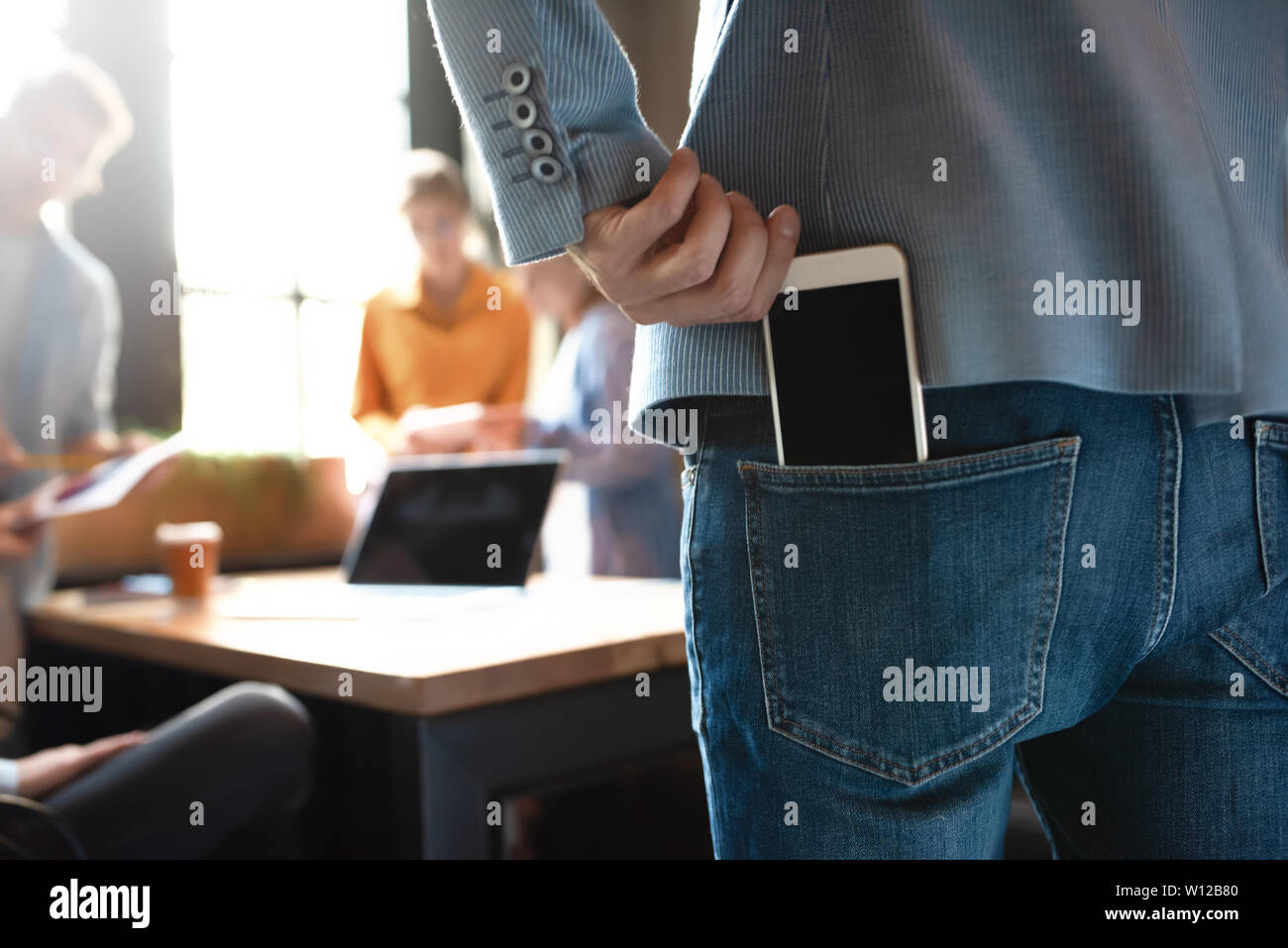 Group of colleagues having meeting in boardroom while working on big presentation and preparing their business strategy. Creative designers looking br Stock Photo