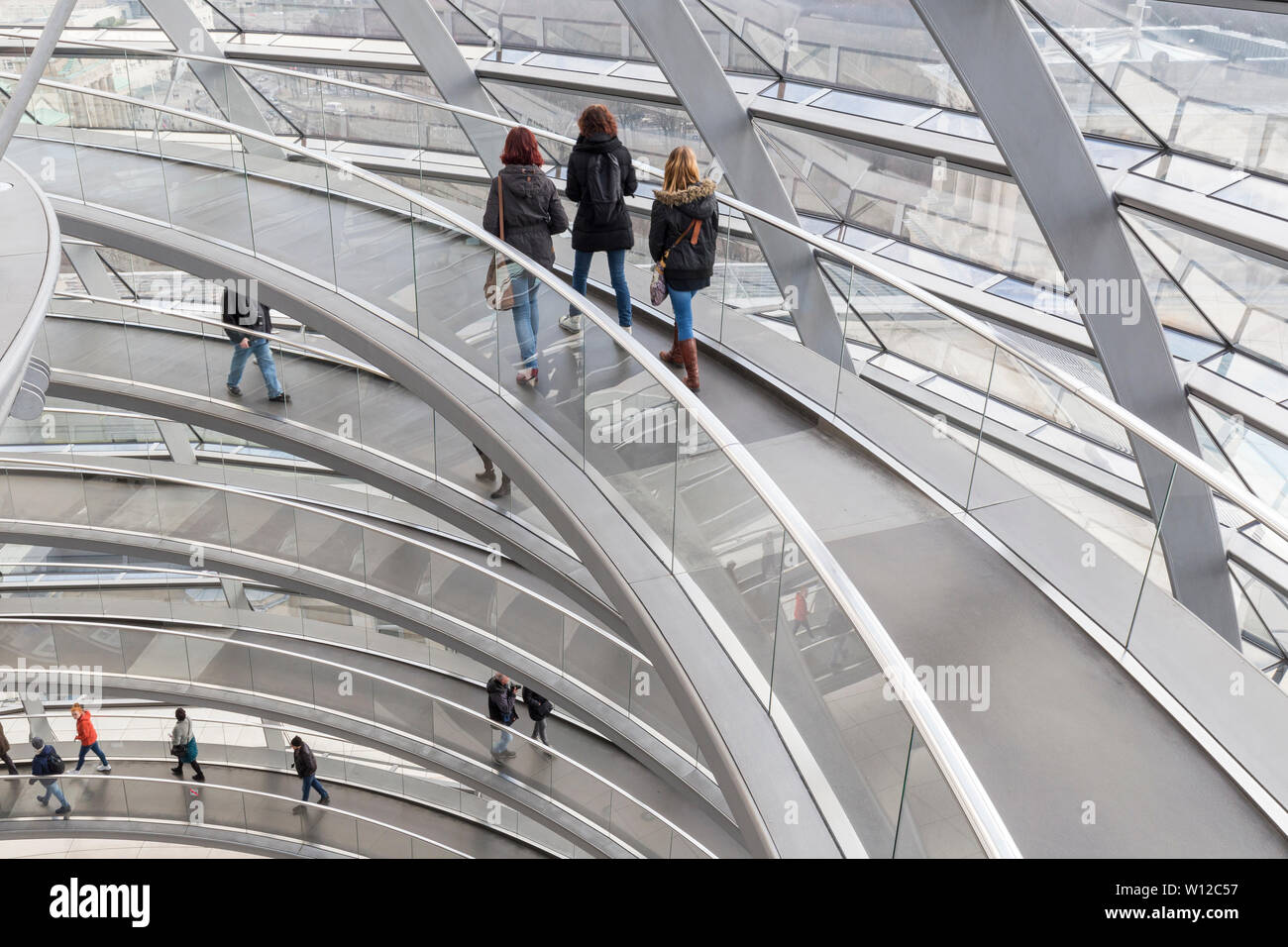 Germany Building Ramp Several tourists walking at ramps inside the futuristic glass dome on ...