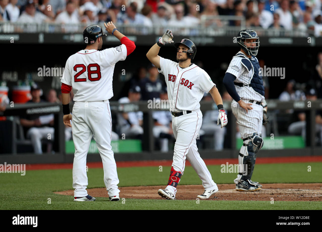 Boston Red Sox' Micheal Chavis and J. D. Martinez celebrate scoring a home run during the MLB London Series Match at The London Stadium. Stock Photo
