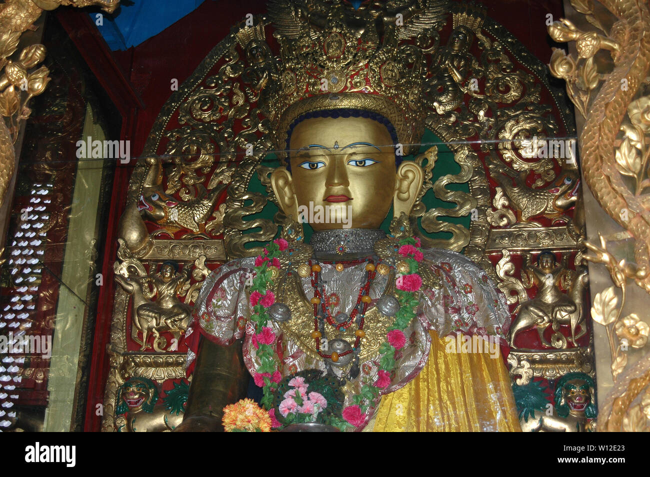 Buddha statue in colorful clothes in a Tibetan monastery Stock Photo Alamy