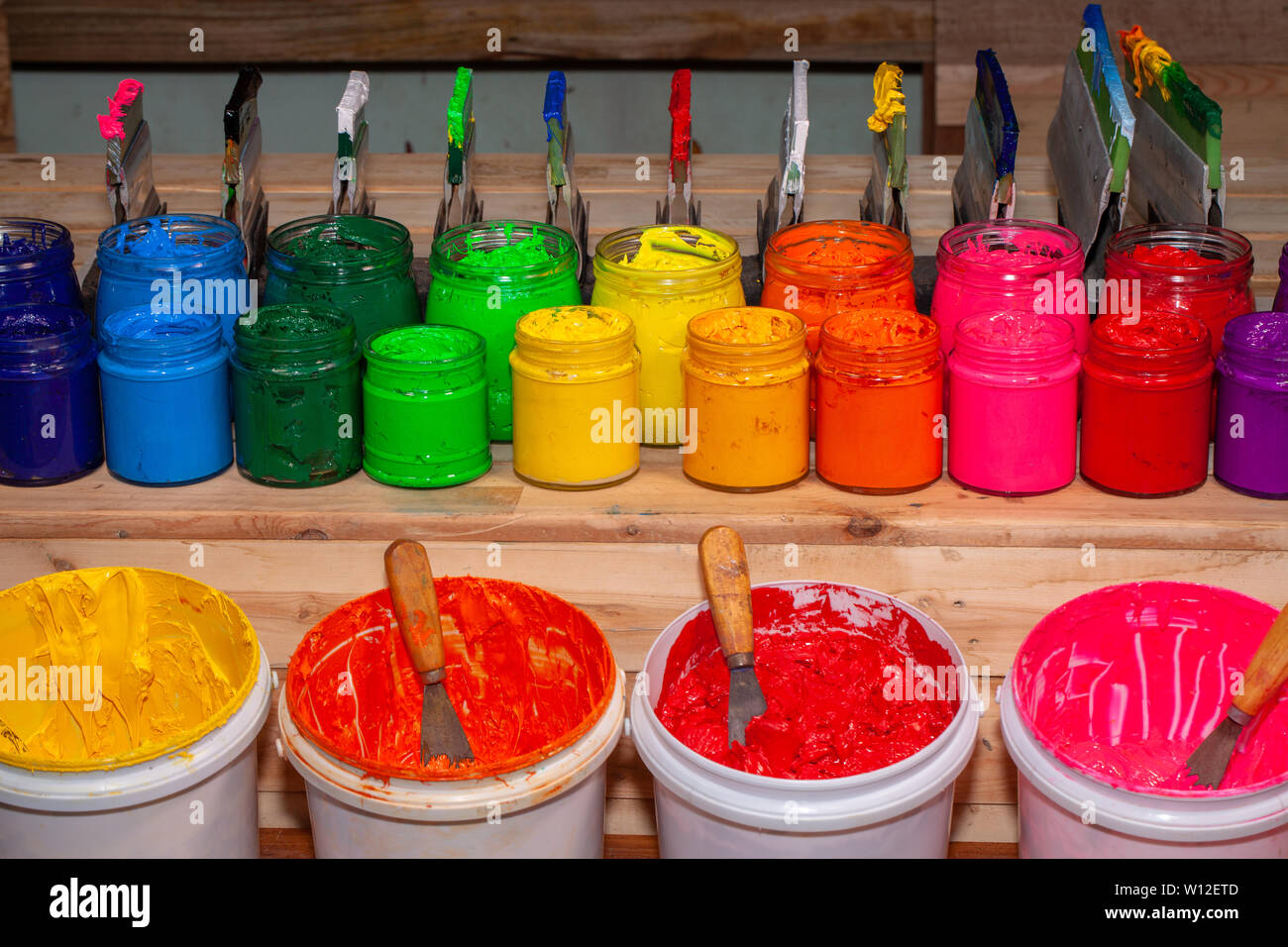 several colors plastisol ink cans in factory who use plastisol ink to print  tee shirt and print on fabric. Plastisol ink useful in tee shirt factory  Stock Photo - Alamy
