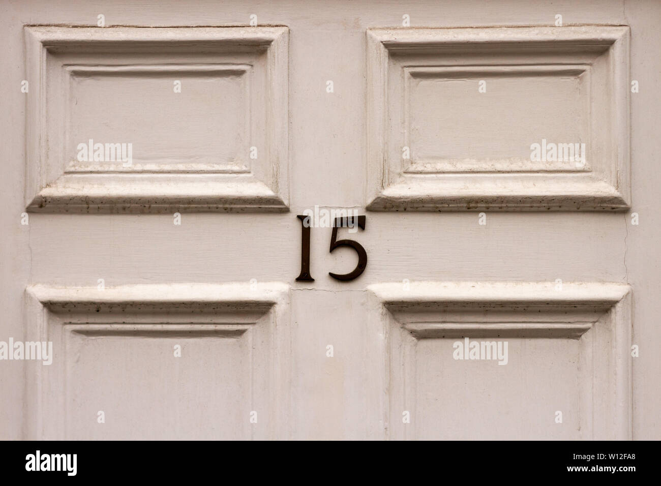 House number 15 with the fifteen on a white carved door Stock Photo