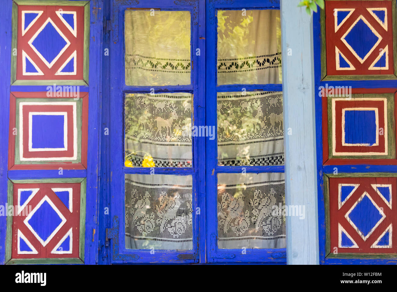 Bucharest, Romania - August 15th, 2018: A decorated window in a traditional romanian country house in Dimitrie Gusti National Village Museum Stock Photo