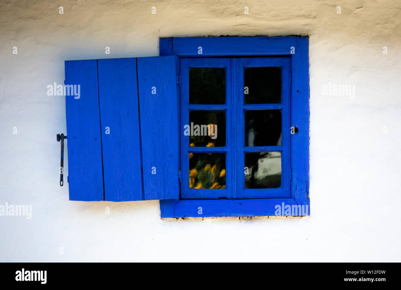 Bucharest, Romania - August 15th, 2018: A blue window in a traditional romanian country house in Dimitrie Gusti National Village Museum Stock Photo