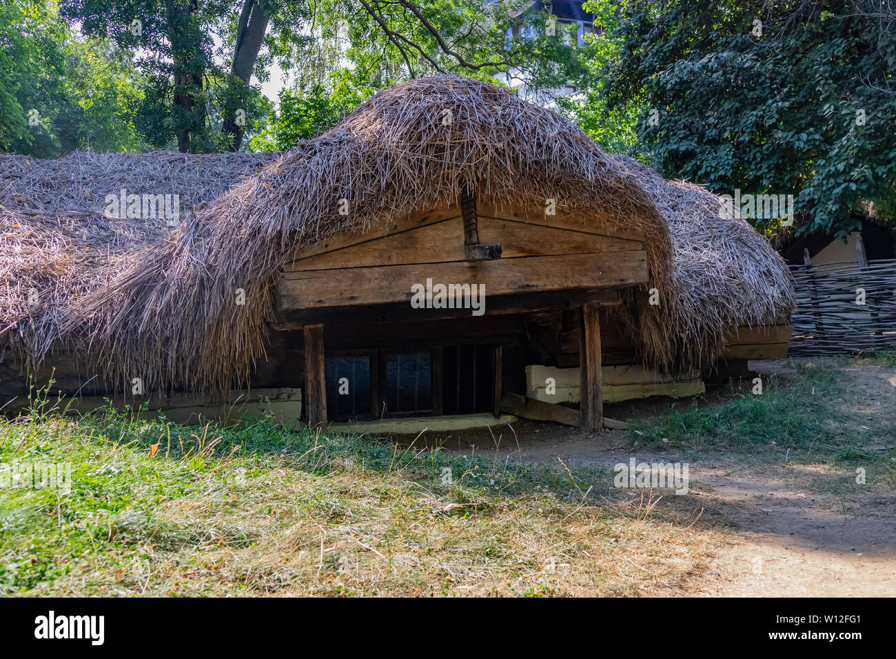 Bucharest, Romania - August 15th, 2018: An underground house in Dimitrie Gusti National Village Museum Stock Photo