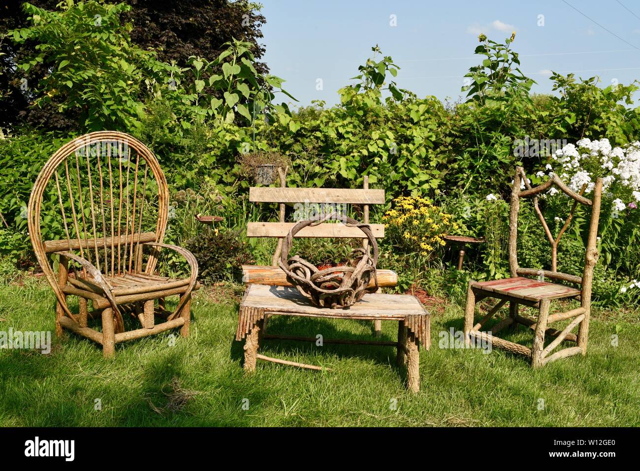 Rustic, wooden hand crafted outdoor furniture chairs and table set in
