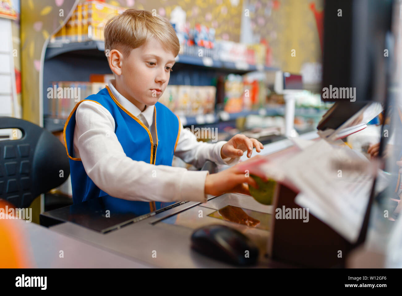 Boy in uniform at the register playing salesman Stock Photo Alamy