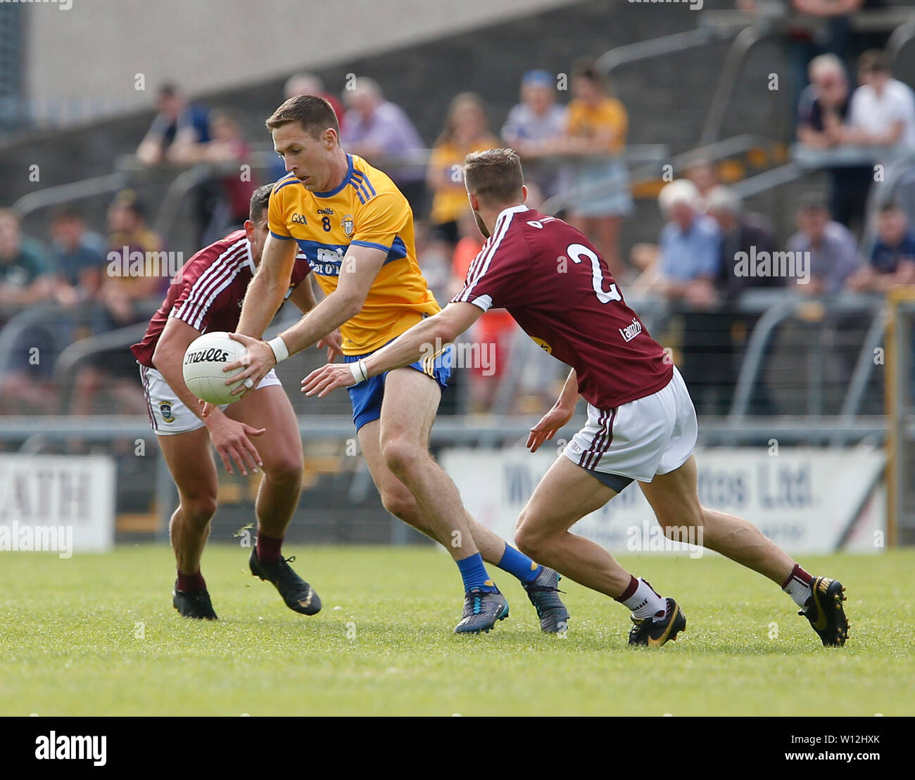 Westmeath, Ireland. 29th June 2019.  TEG Cusack Park, Mullingar, Westmeath, Ireland; GAA Gaelic Football round 3, Westmeath versus Clare; Gary Brennan (Clare) gets away from Kevin Maguire and Denis Corroon (Westmeath) Credit: Action Plus Sports Images/Alamy Live News Stock Photo