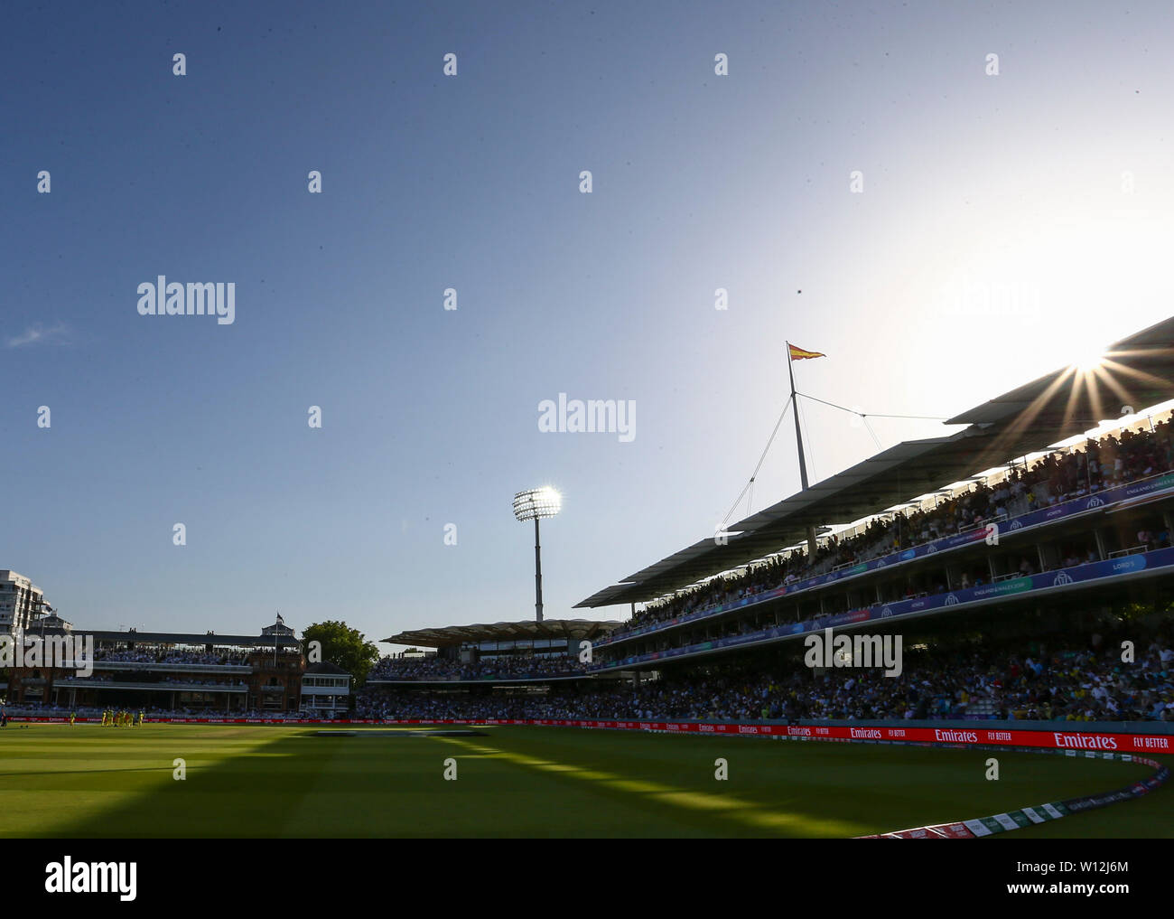 London, UK. 29th June, 2019. 29th June 2019, Lords Cricket Ground, London, England, ICC World Cup Cricket, New Zealand versus Australia; The sun starts to go down behind the Grand Stand as the players take a drinks break Credit: Action Plus Sports Images/Alamy Live News Stock Photo