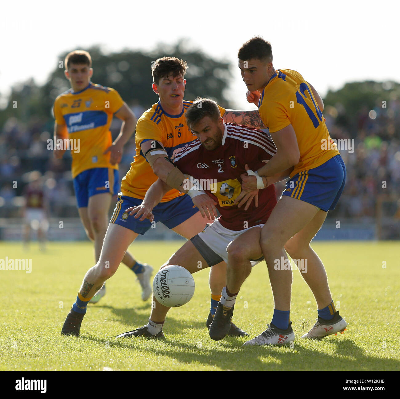 Westmeath, Ireland. 29th June 2019.  TEG Cusack Park, Mullingar, Westmeath, Ireland; GAA Gaelic Football round 3, Westmeath versus Clare; Kevin Maguire (Westmeath) battles for possession against Jamie Malone and Aaron Fitzgerald (Clare) Credit: Action Plus Sports Images/Alamy Live News Stock Photo