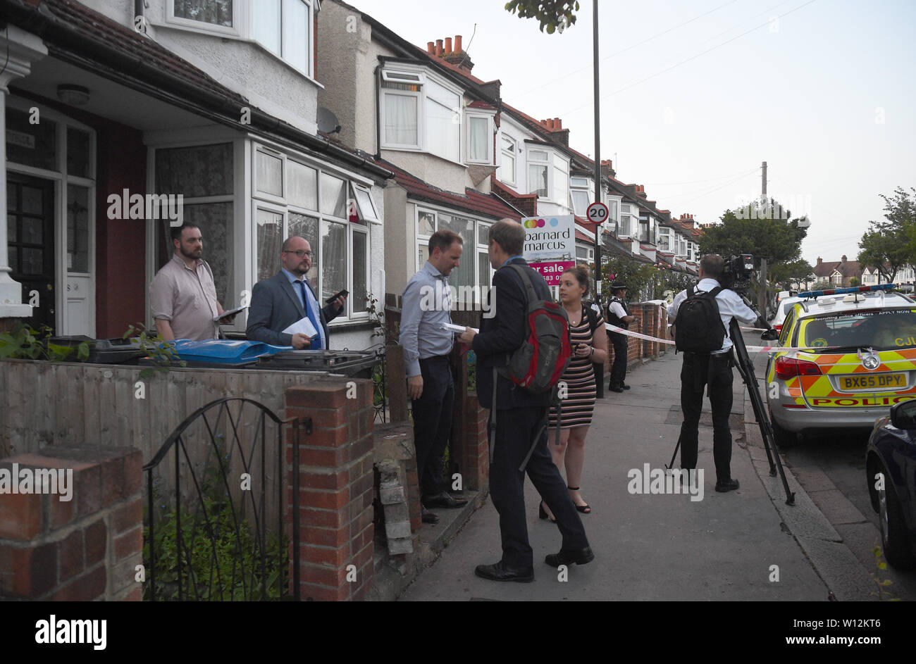 Police officers carrying door to door inquiries in Raymead Avenue, Thornton Heath, Croydon where a women who was around eight months pregnant has been stabbed to death and her baby is critically ill in hospital. Stock Photo