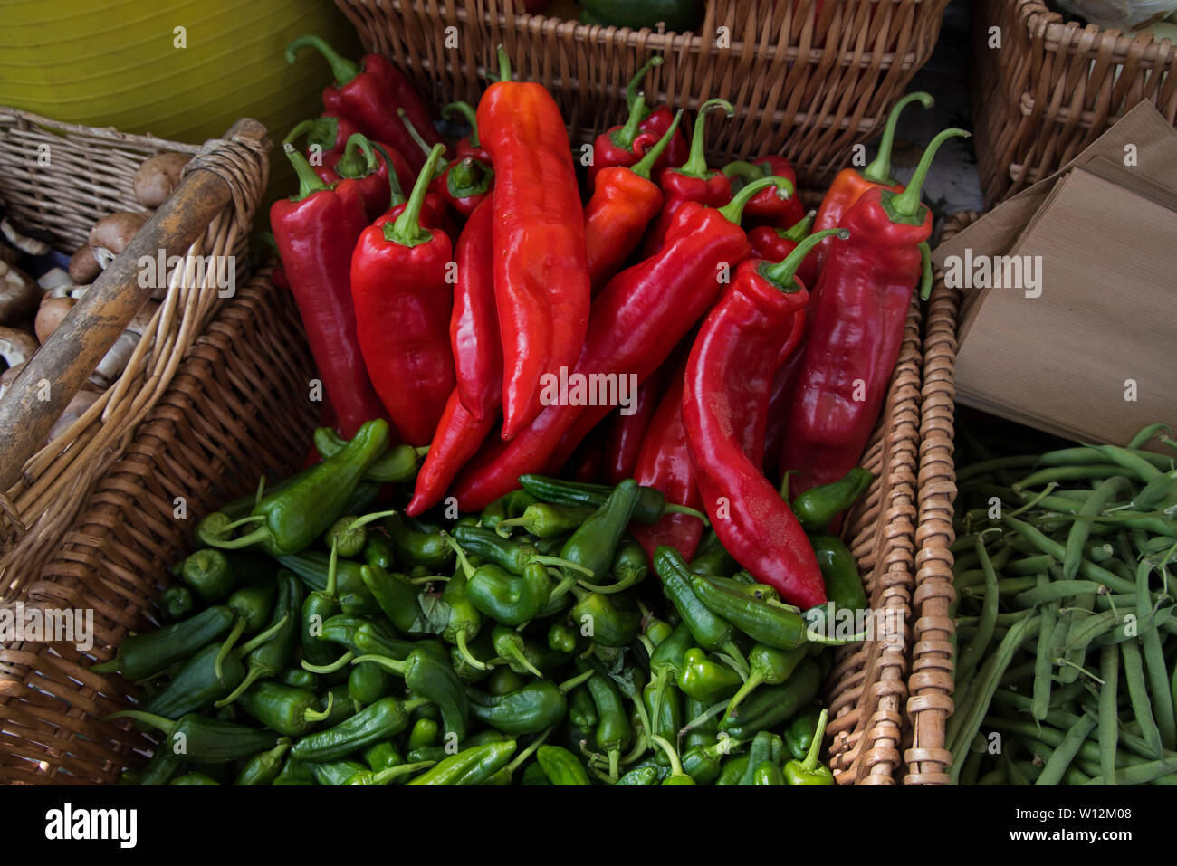 Red peppers and green chillies on display at the Farmer's Market on Castle Terrace, Edinburgh, Scotland, UK. Stock Photo