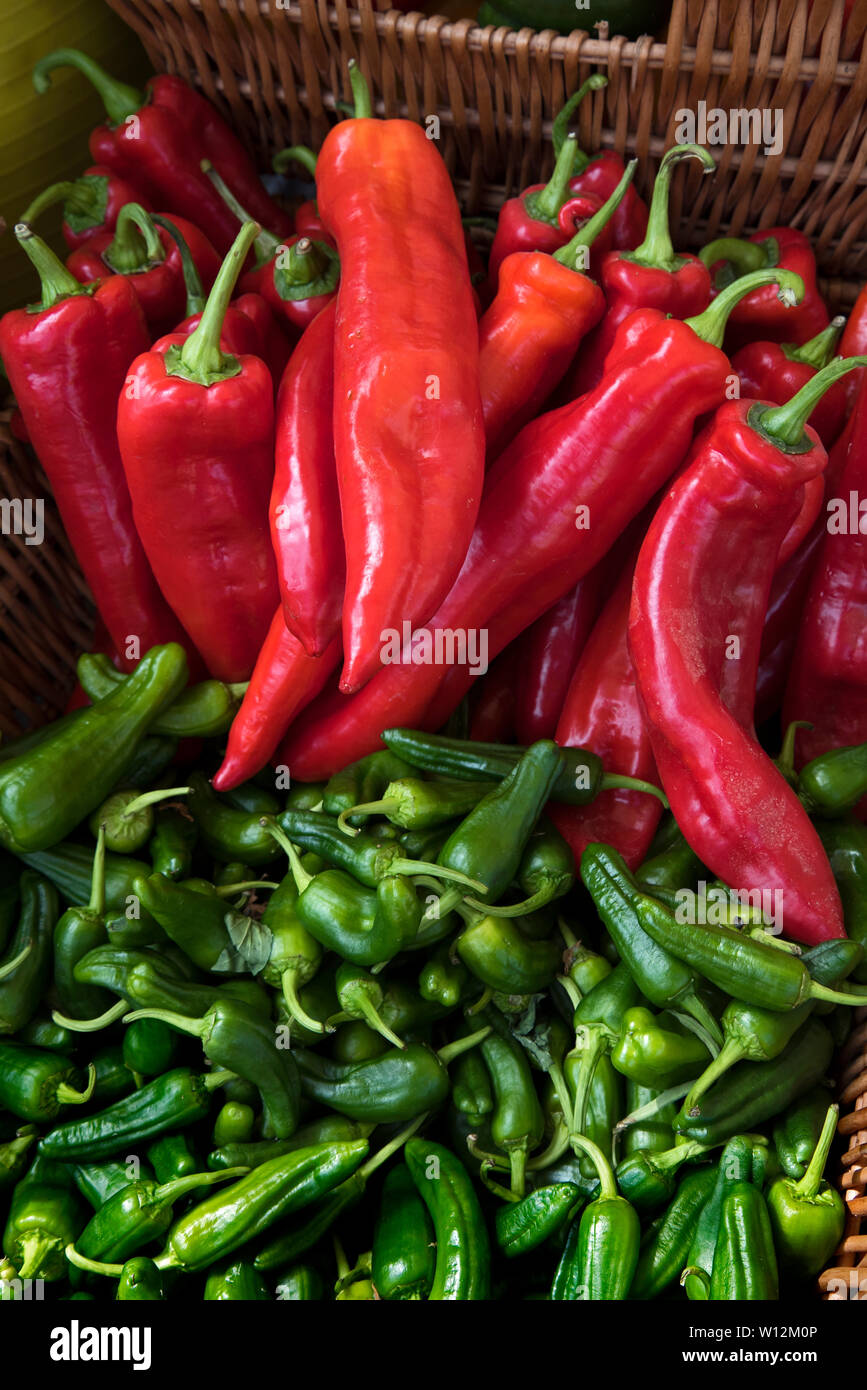 Red peppers and green chillies on display at the Farmer's Market on Castle Terrace, Edinburgh, Scotland, UK. Stock Photo