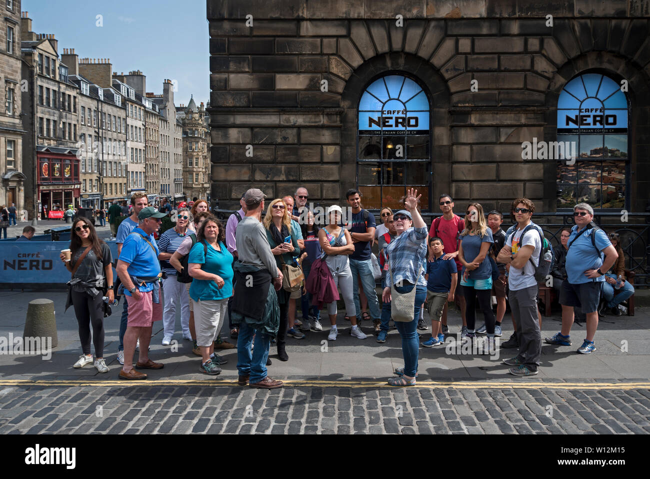 A walking tour on the corner of Parliament Square and High Street, Edinburgh, Scotland, UK. Stock Photo