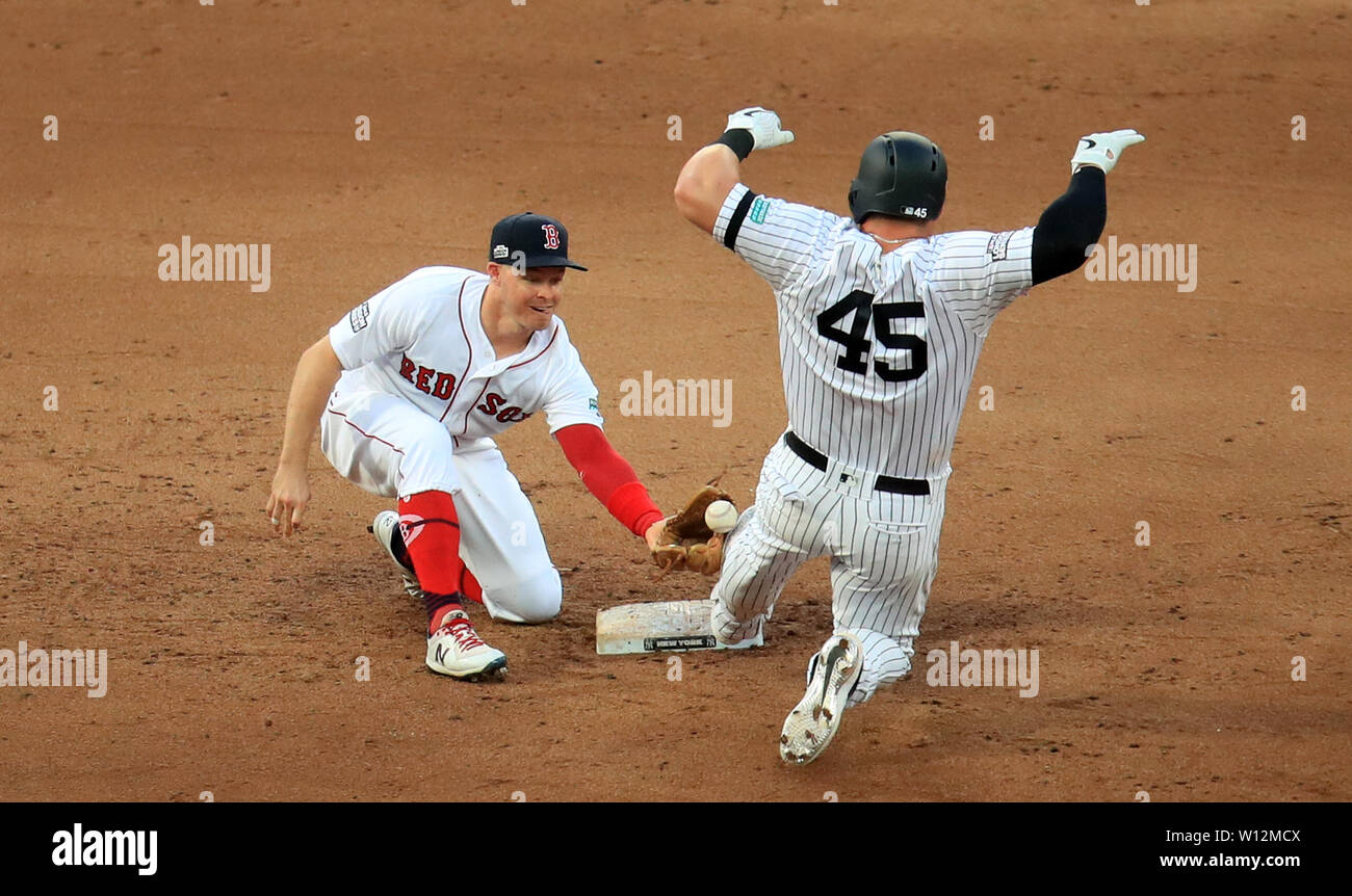 New York Yankees' Luke Voit (right) in action with Boston Red Sox' Brock Holt during the MLB London Series Match at The London Stadium. Stock Photo