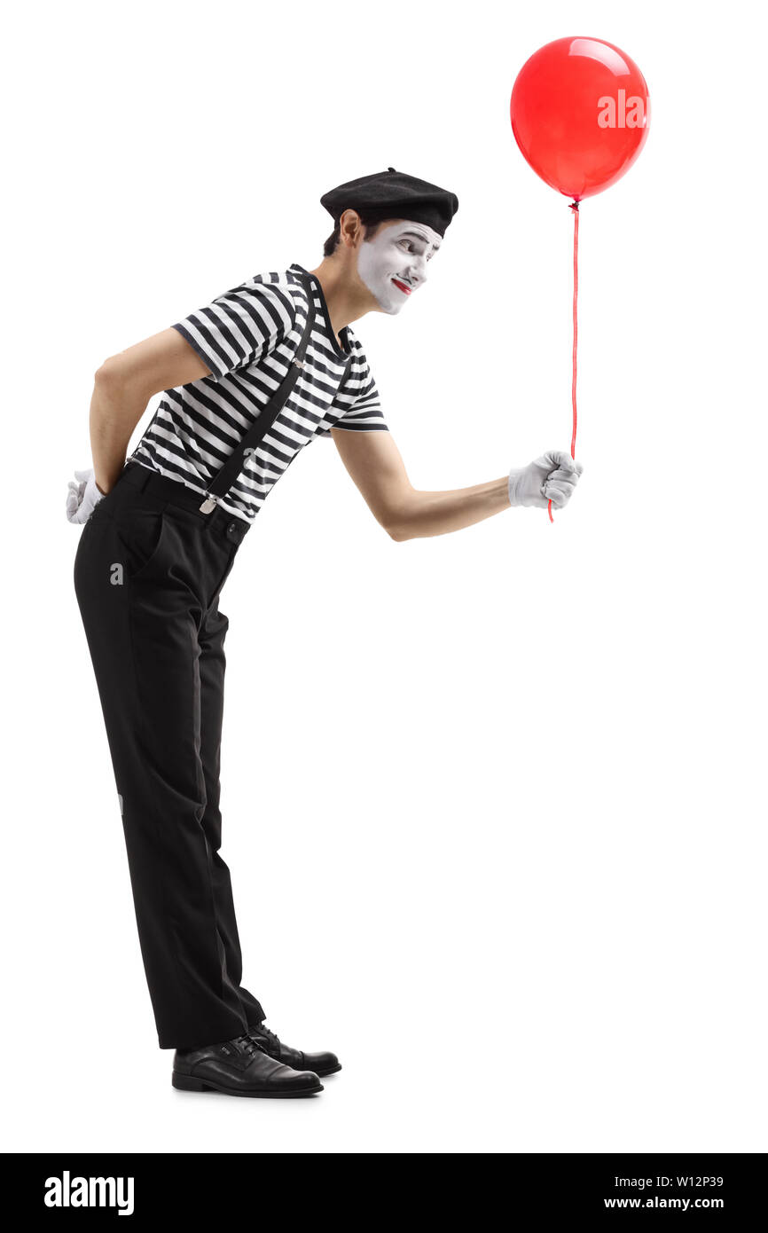 Full length shot of a mime giving a red balloon isolated on white background Stock Photo