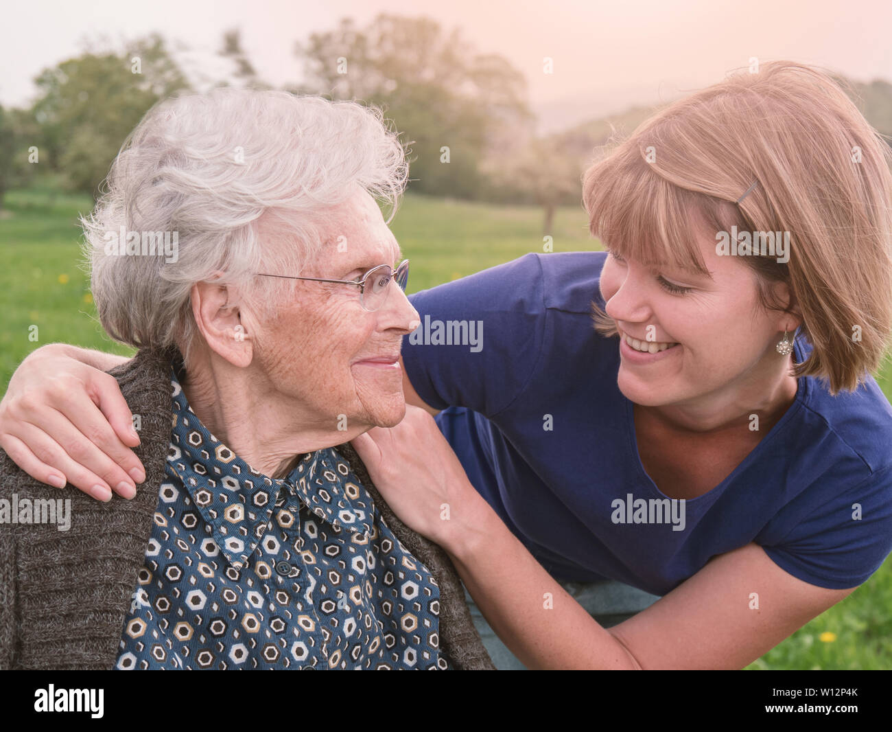Portrait of senior woman with smiling caregiver Stock Photo