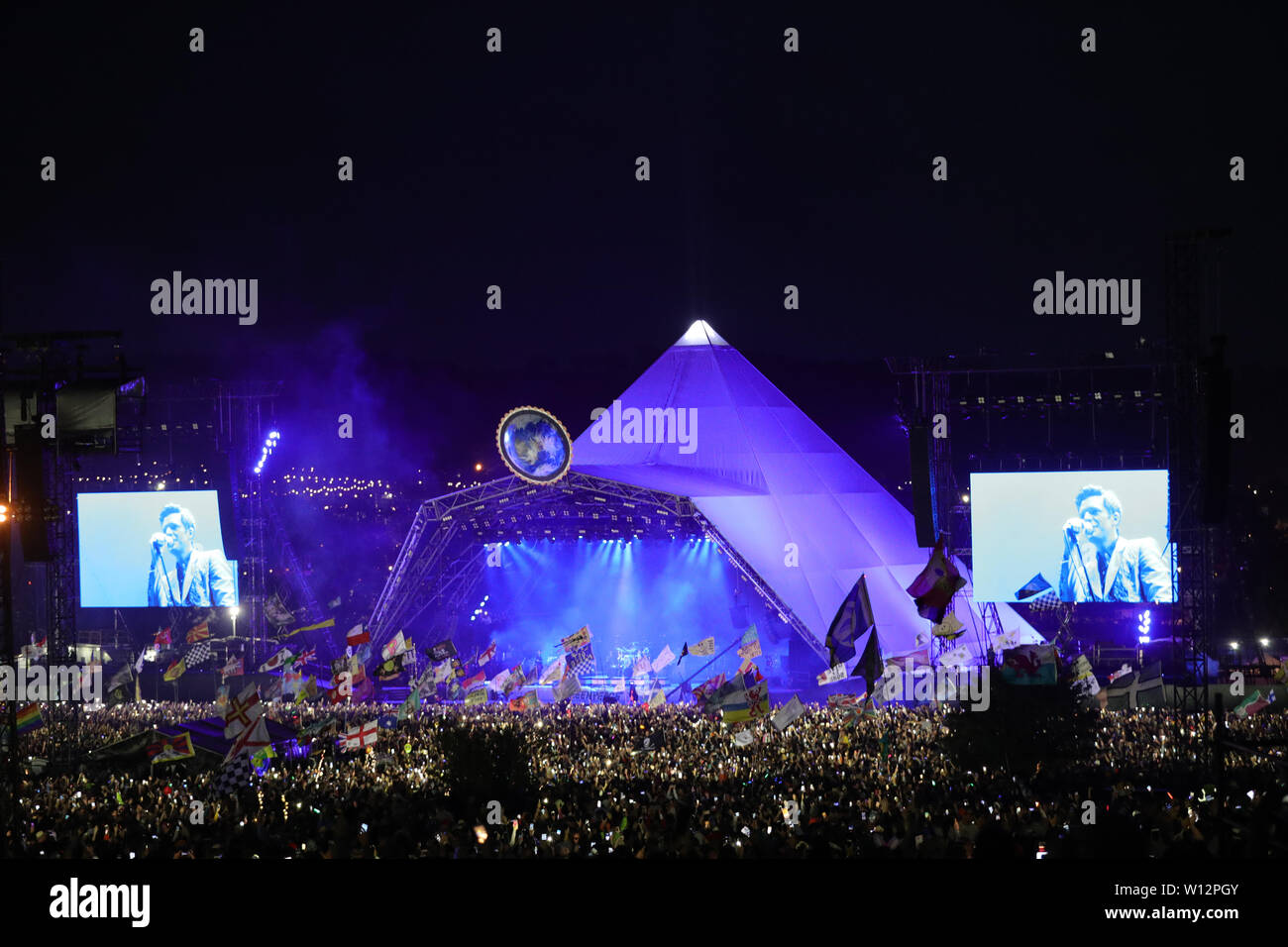 The Killers plays the Pyramid Stage on the fourth day of the Glastonbury Festival at Worthy Farm in Somerset. Stock Photo