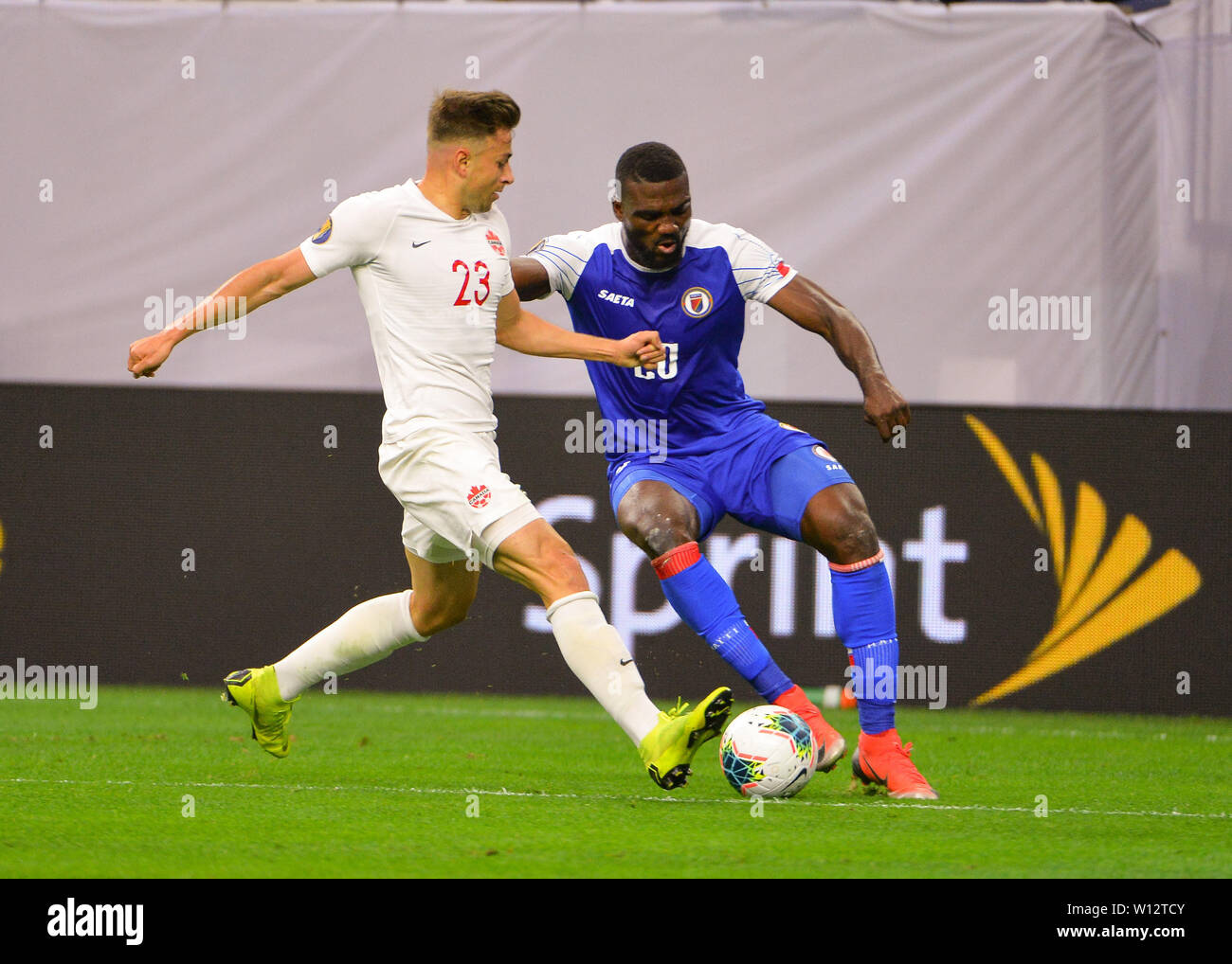 Houston, TX, USA. 29th June, 2019. Canada defender, Marcus Godindo (23), and Haiti forward, Frantzdy Pierrot (20), work for control of the ball during the 2019 CONCACAF Gold Cup, quarter final match between Haiti and Canada, at NRG Stadium in Houston, TX. Mandatory Credit: Kevin Langley/Sports South Media/CSM/Alamy Live News Stock Photo