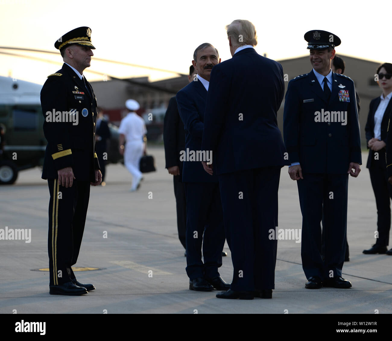 Ambassador Harry Harris, United States Embassy and Consulate in Korea, greets President Donald J. Trump, on the flightline at Osan Air Base, Republic of Korea, June 29, 2019. The U.S. State Department and the Department of Defense work closely together on the peninsula in support of long-term stability in the Indo-Pacific region.  (U.S. Air Force photo by Staff Sgt. Sergio A. Gamboa) Stock Photo