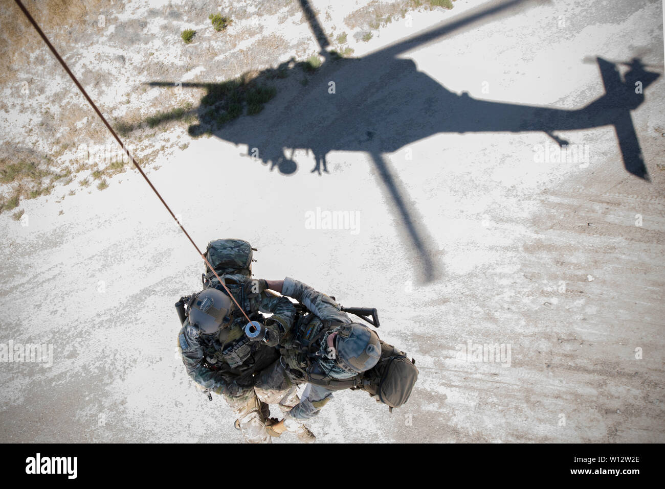 Two pararescuemen assigned to the 66th Rescue Squadron hoist themselves out of an HH-60 Pave Hawk during the Joint Civilian Orientation Conference (JCOC) 91 at Nellis Air Force Base, Nev., June 26, 2019. The JCOC was established in 1948 as a Secretary of Defense-sponsored annual outreach program during which business and community leaders experience military life, training and operations. (U.S. Air Force photo by Airman 1st Class Jeremy Wentworth) Stock Photo