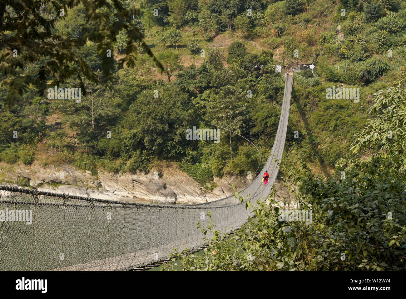 Suspension footbridge from Narayanghat-Mugling Highway to southern side of Seti Gandaki River near the Presidency Resort, Chitwan District, Nepal Stock Photo