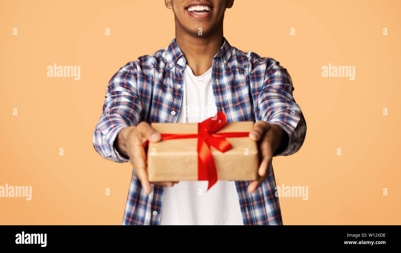 Guy Offering Cheerful Guy Offering Exclusive Gift Box to Camera Stock Photo - Alamy