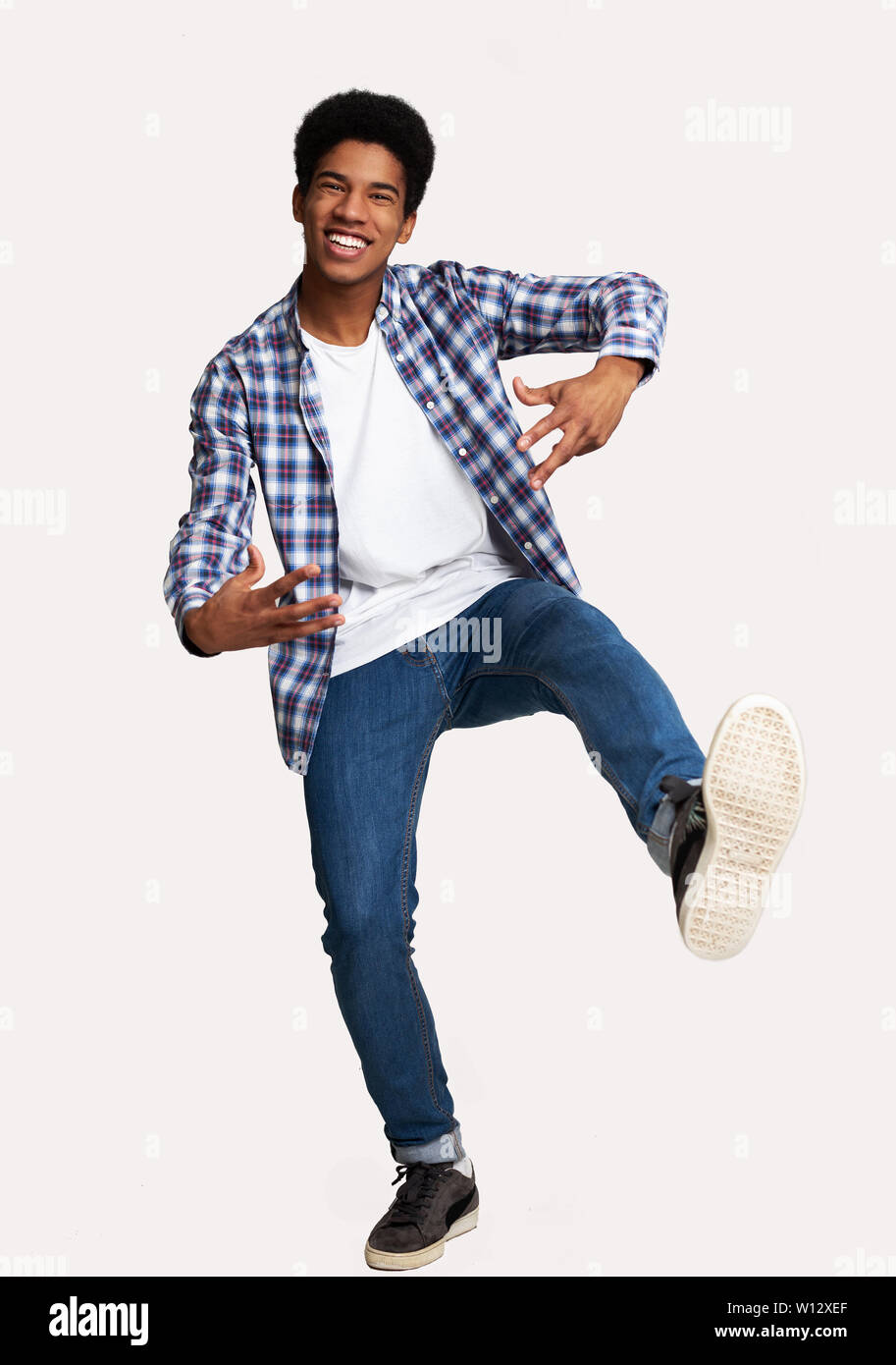 Just Having Fun. Excited Guy Jumping Against White Background Stock Photo