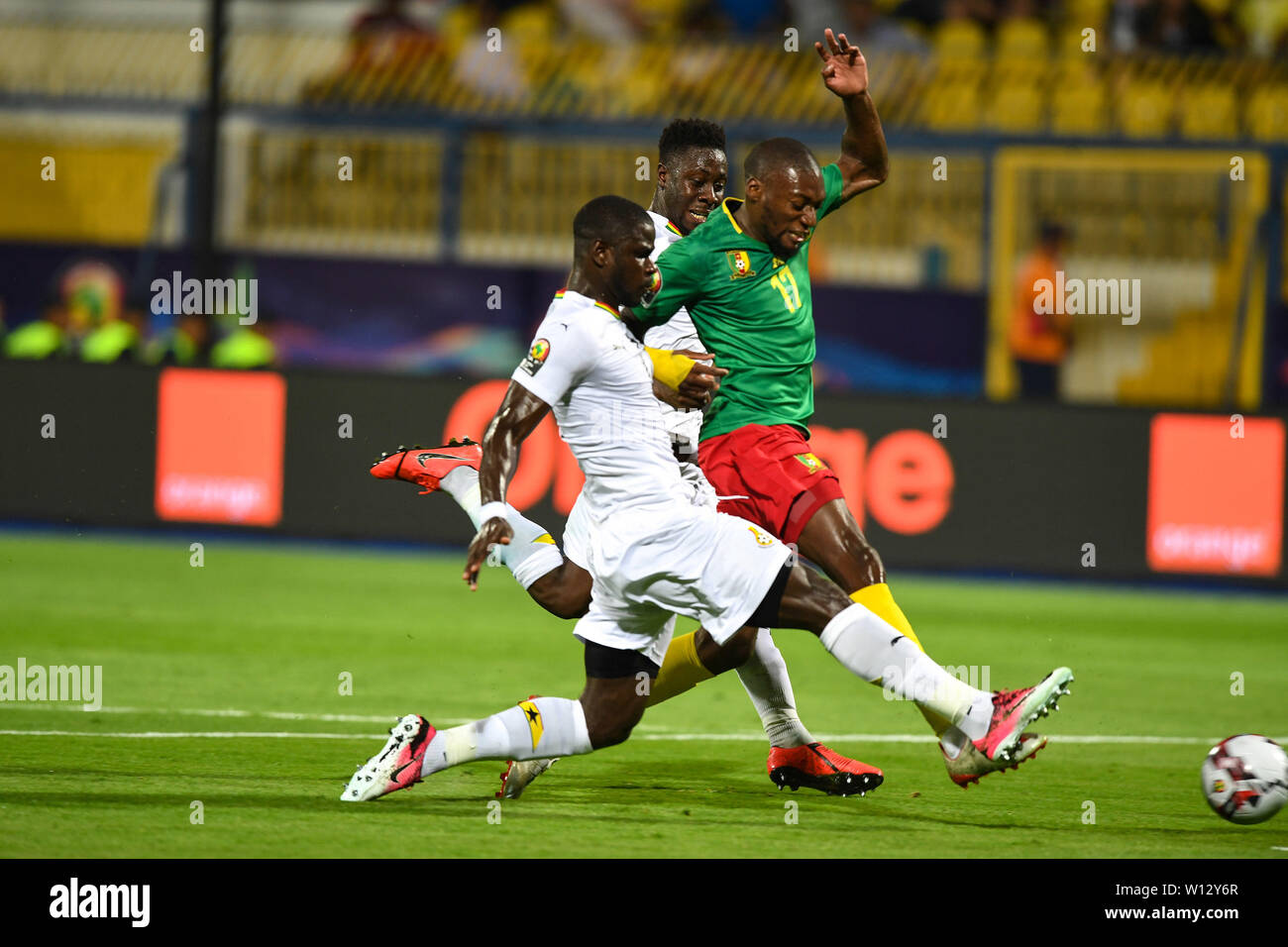 Ismailia, Egypt. 29th June, 2019. Karl Brillant Toko Ekambi (R) of Cameroon vies with Jonathan Mensah and Andrew Kyere-Yiadom of Ghana during the 2019 Africa Cup of Nations Group F match between Cameroon and Ghana in Ismailia, Egypt, on June 29, 2019. The match ended with a 0-0 draw. Credit: Li Yan/Xinhua/Alamy Live News Stock Photo