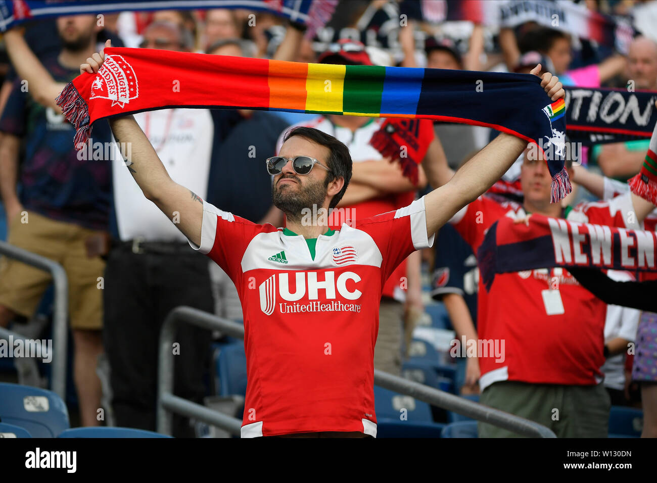 Regulation Time. 29th June, 2019. A fan holds up a pride scarf during the national anthem before the MLS game between the Houston Dynamo and the New England Revolution held at Gillette Stadium in Foxborough Massachusetts. The Revolution defeat the Dynamo 2-1 in regulation time. Eric Canha/CSM/Alamy Live News Stock Photo
