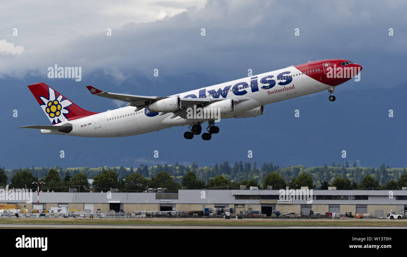 Richmond, British Columbia, Canada. 27th June, 2019. An Edelweiss Air Airbus A340-313X (HB-JME) wide-body jet airliner takes off from Vancouver International Airport. The Swiss leisure airline is wholly owned by Swiss International Air Lines, part of the Lufthansa Group. Credit: Bayne Stanley/ZUMA Wire/Alamy Live News Stock Photo