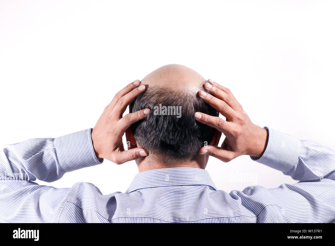 bald businessman with his head on scalp view from behind with white background Stock Photo