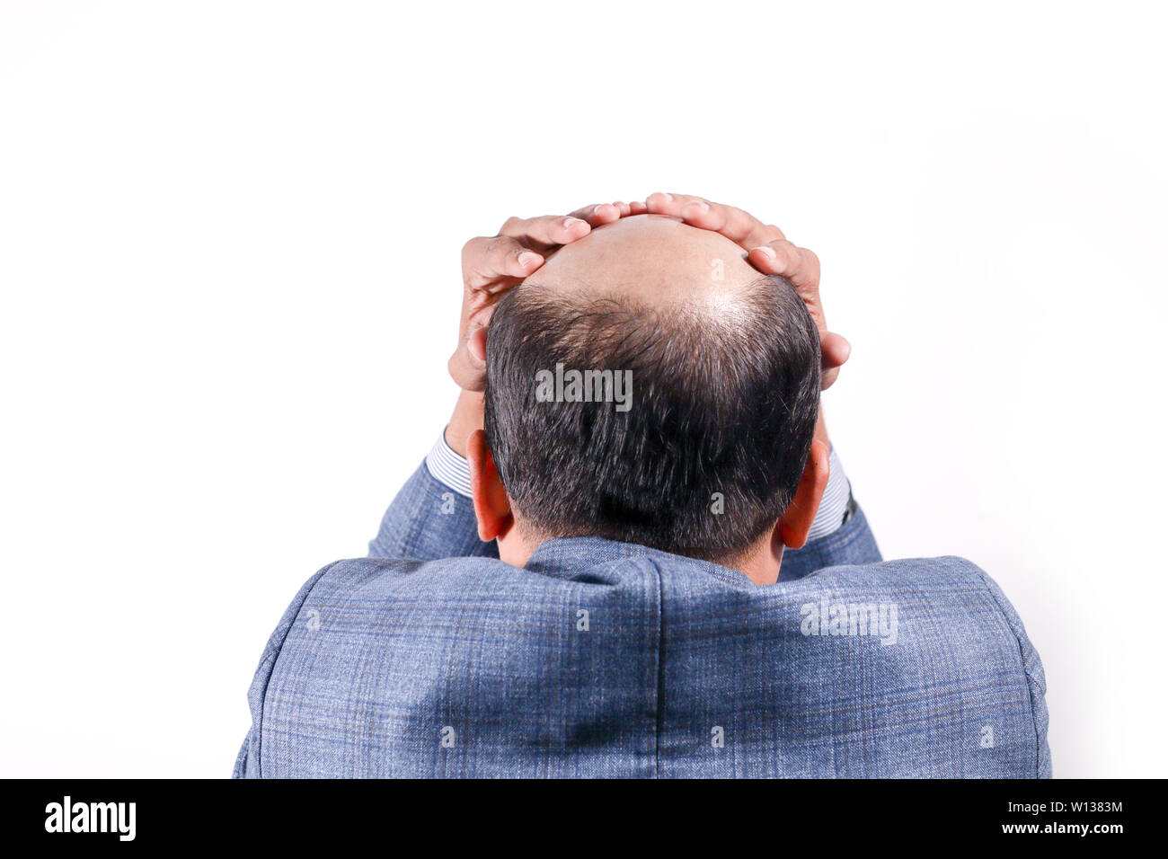 bald businessman with his head on scalp view from behind with white background Stock Photo