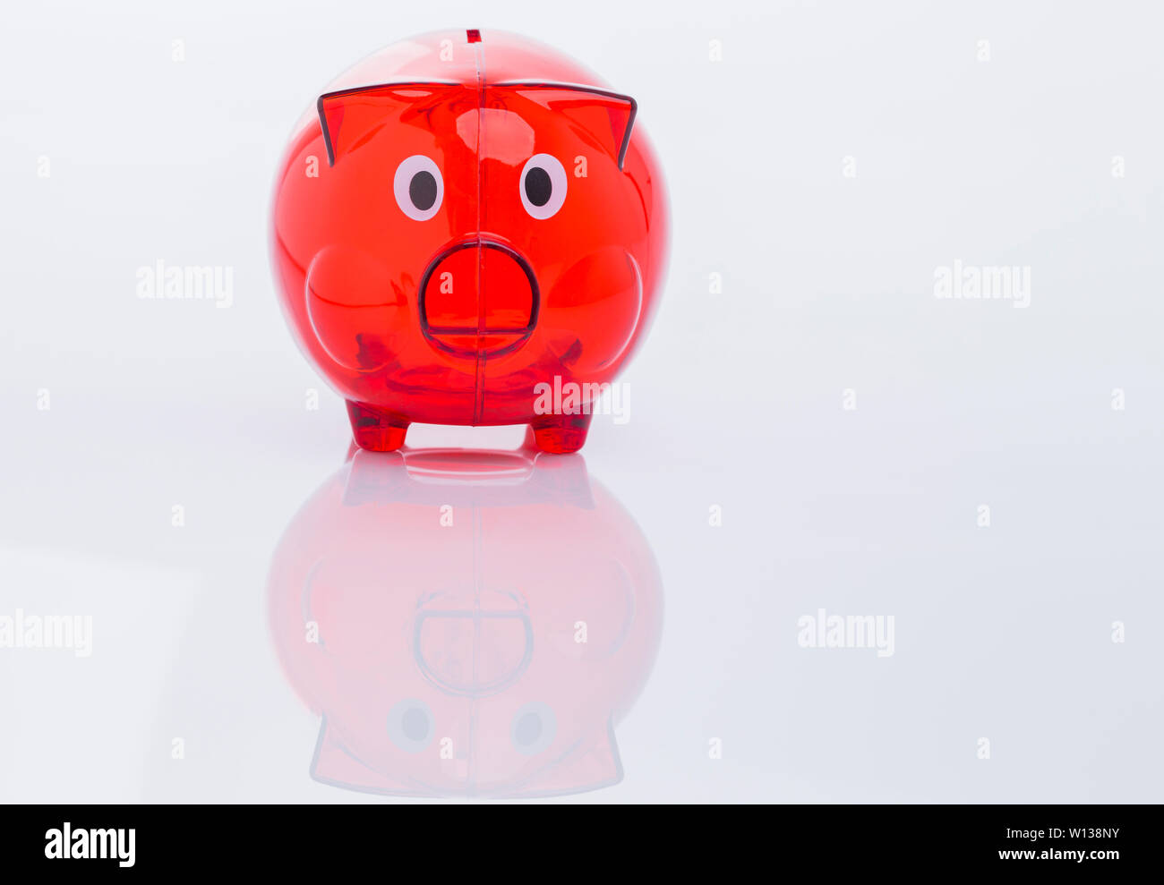 The image shows a red piggy bank, isolated on white background Stock