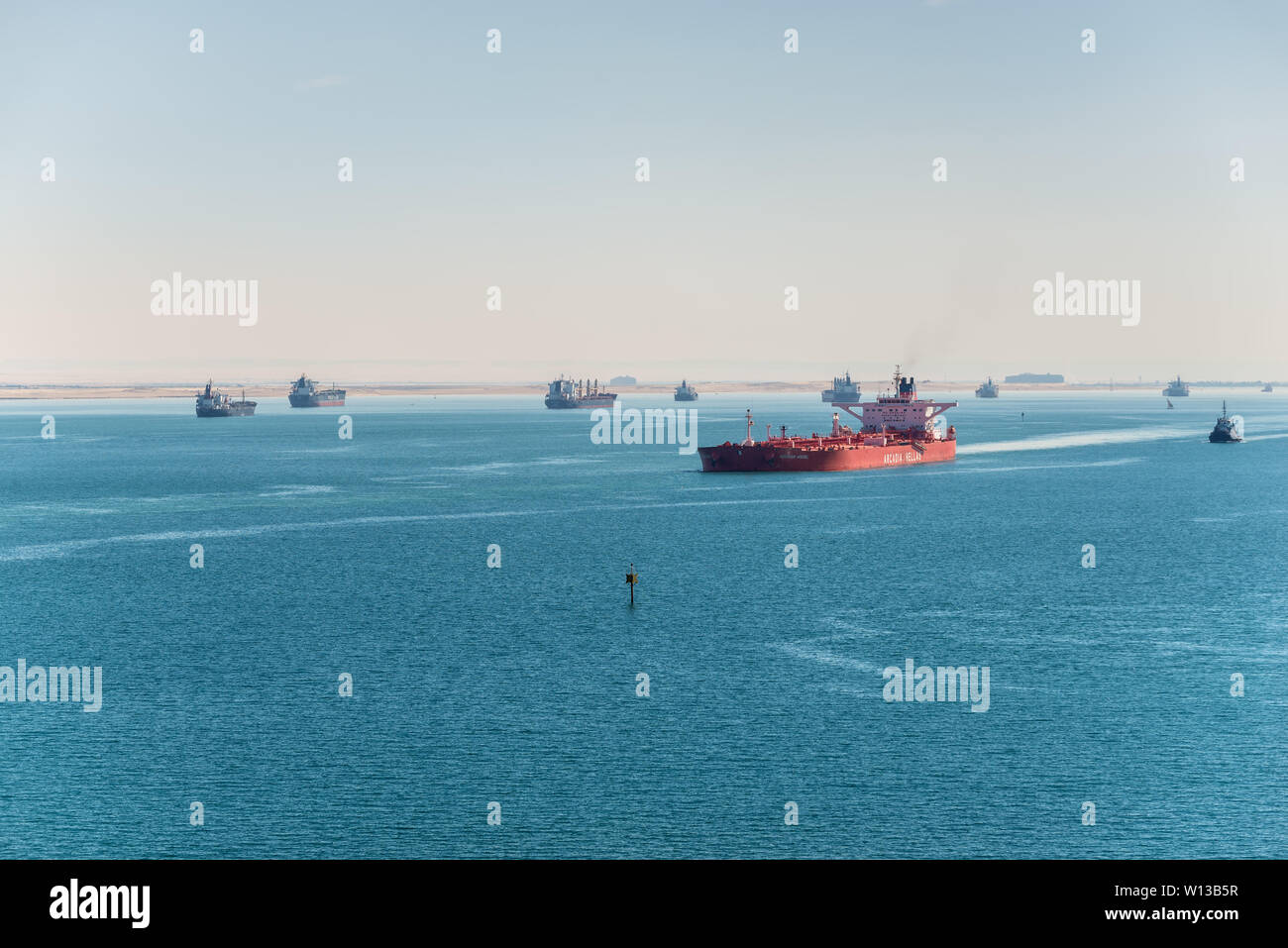 Suez, Egypt - November 5, 2017: Commercial ships southbound through the Great Bitter Lake and wait in line at anchor. This is where the North and Sout Stock Photo