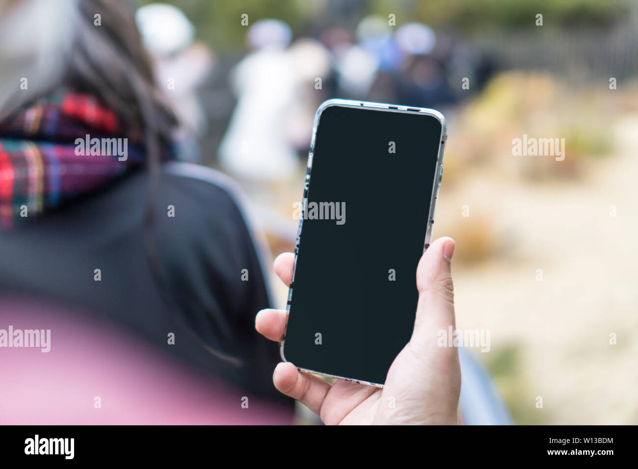 Male hand holding modern blank screen smartphone Stock Photo