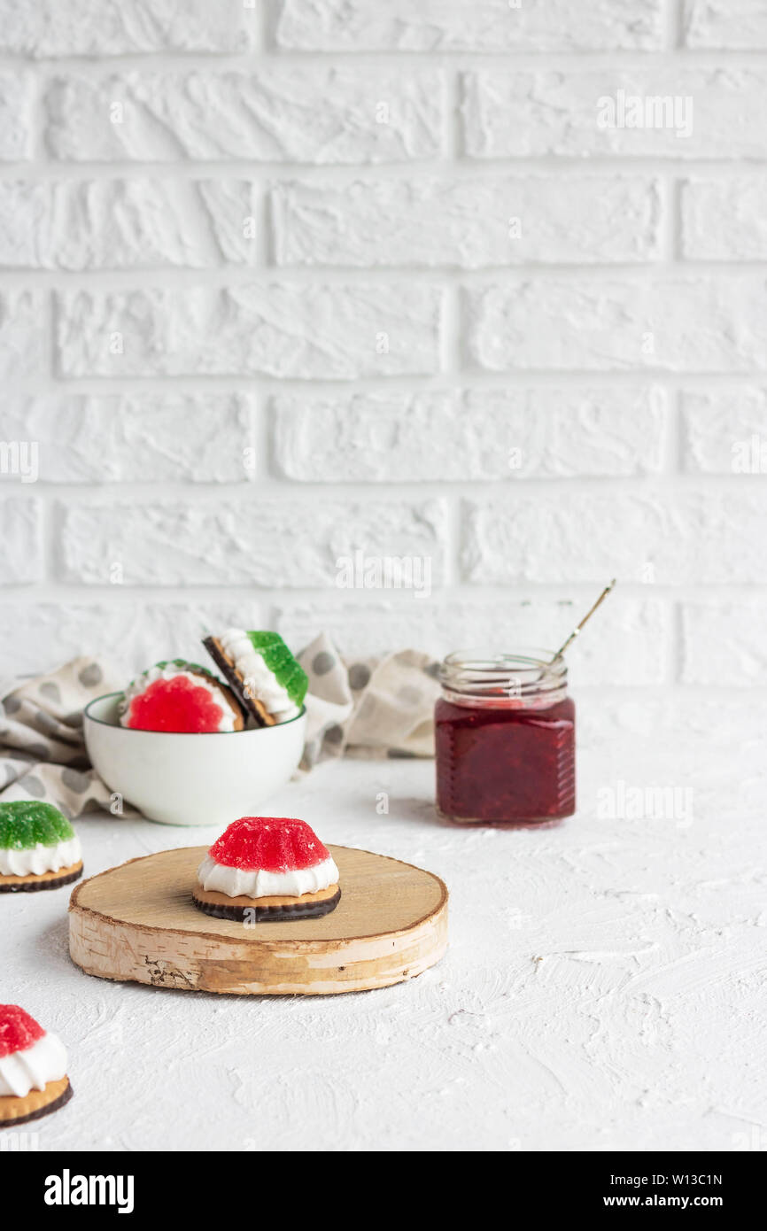 Chocolate-covered biscuits with marshmallow layer and marmalade hat Stock Photo