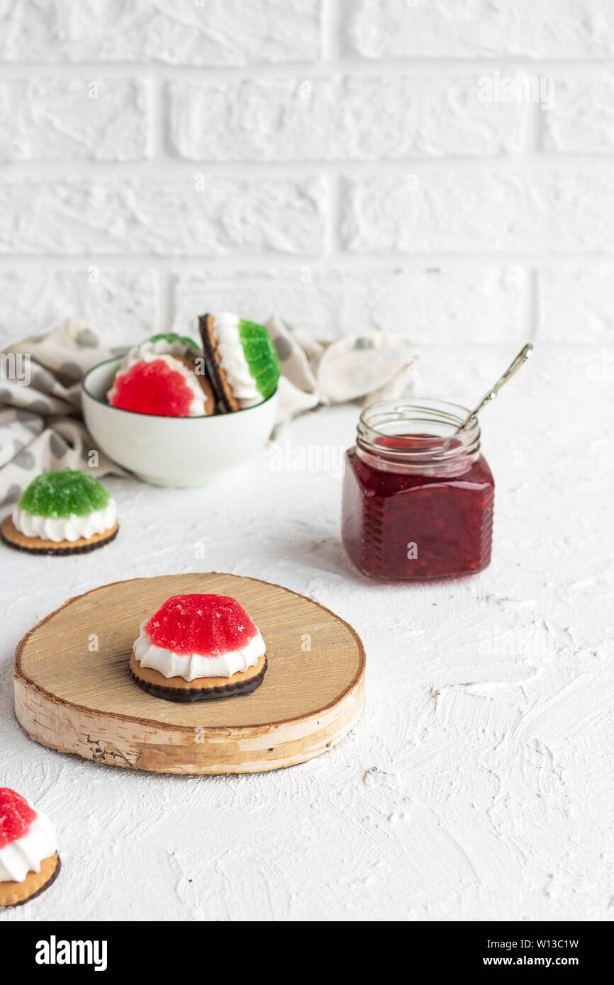 Chocolate-covered biscuits with marshmallow layer and marmalade hat Stock Photo
