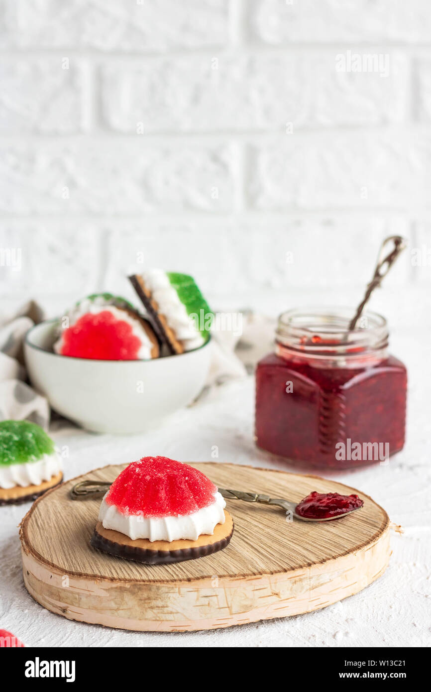 Chocolate-covered biscuits with marshmallow layer and marmalade hat Stock Photo