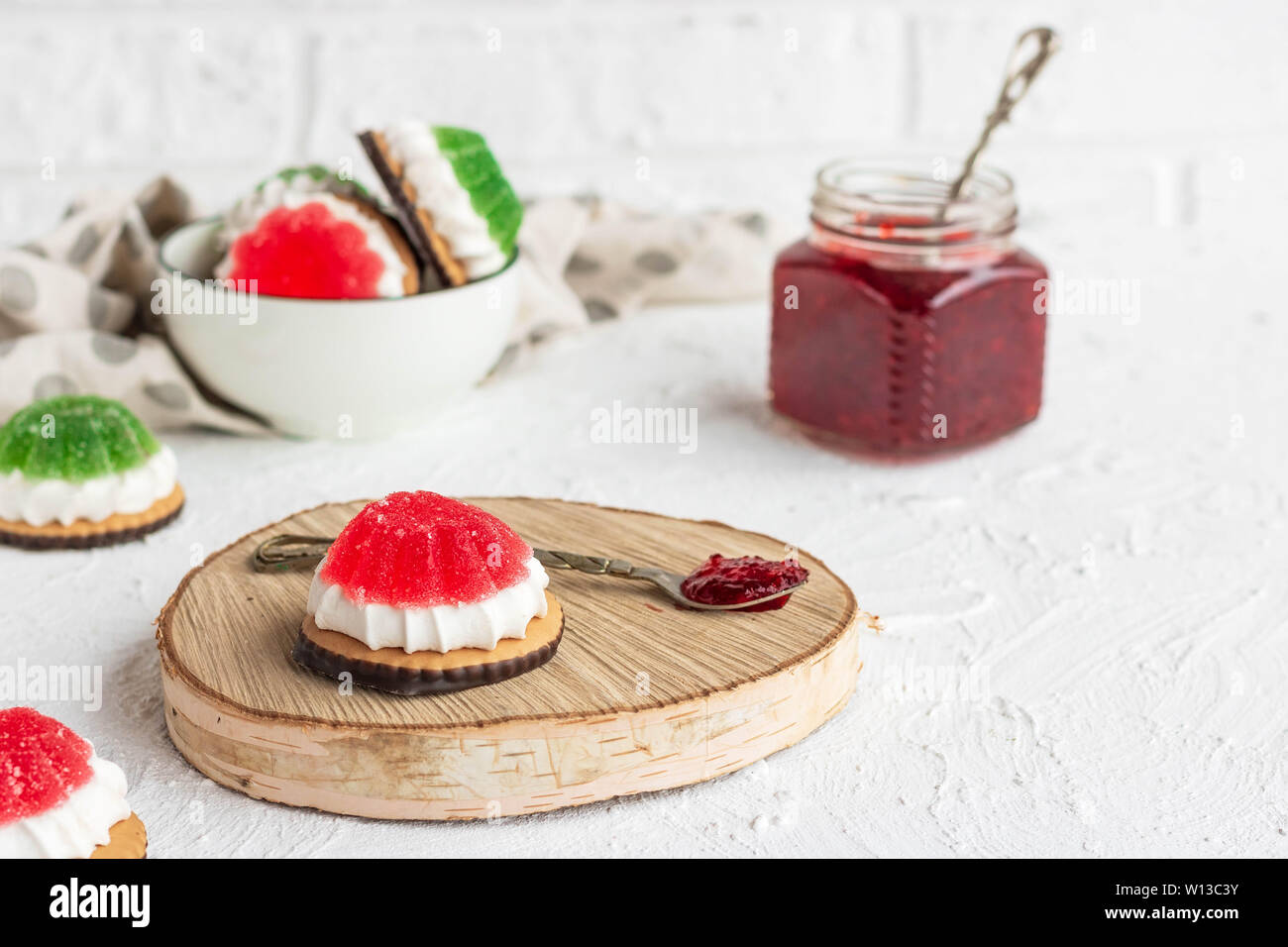 Chocolate-covered biscuits with marshmallow layer and marmalade hat Stock Photo