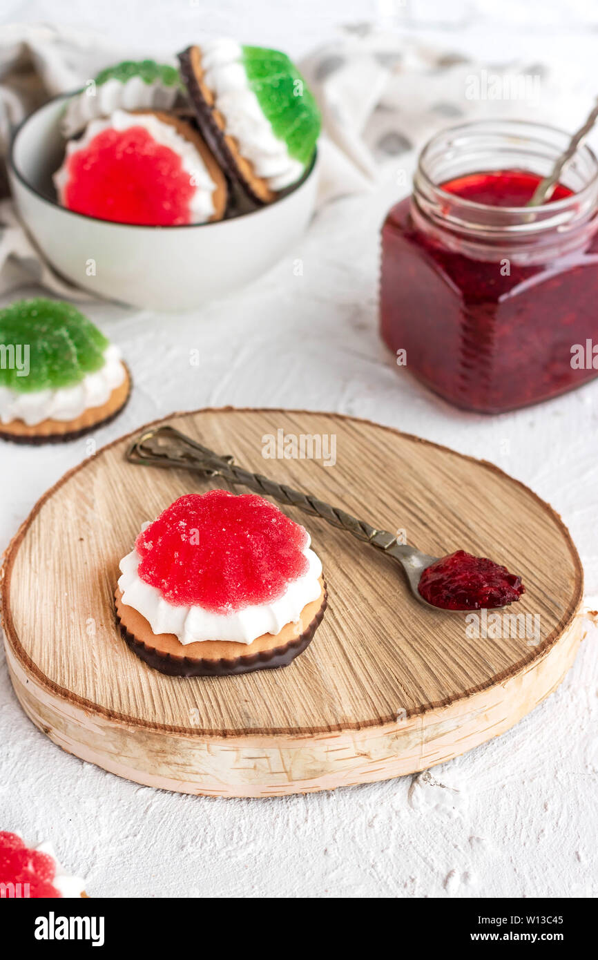 Chocolate-covered biscuits with marshmallow layer and marmalade hat Stock Photo