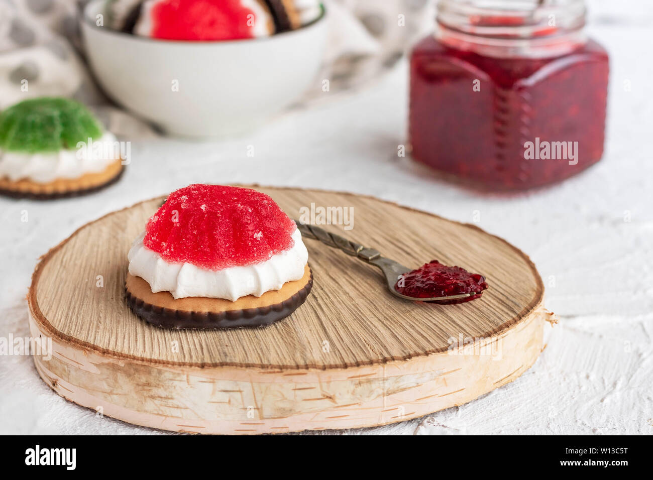 Chocolate-covered biscuits with marshmallow layer and marmalade hat Stock Photo