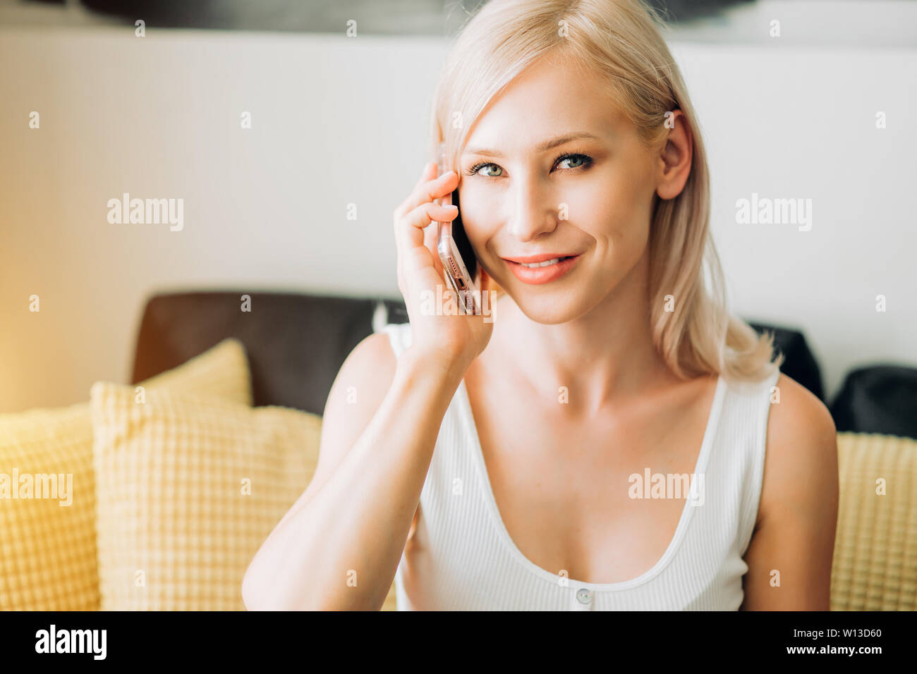 Indoor Close Up Shot Of Lovely Caucasian Female With Blonde Hair