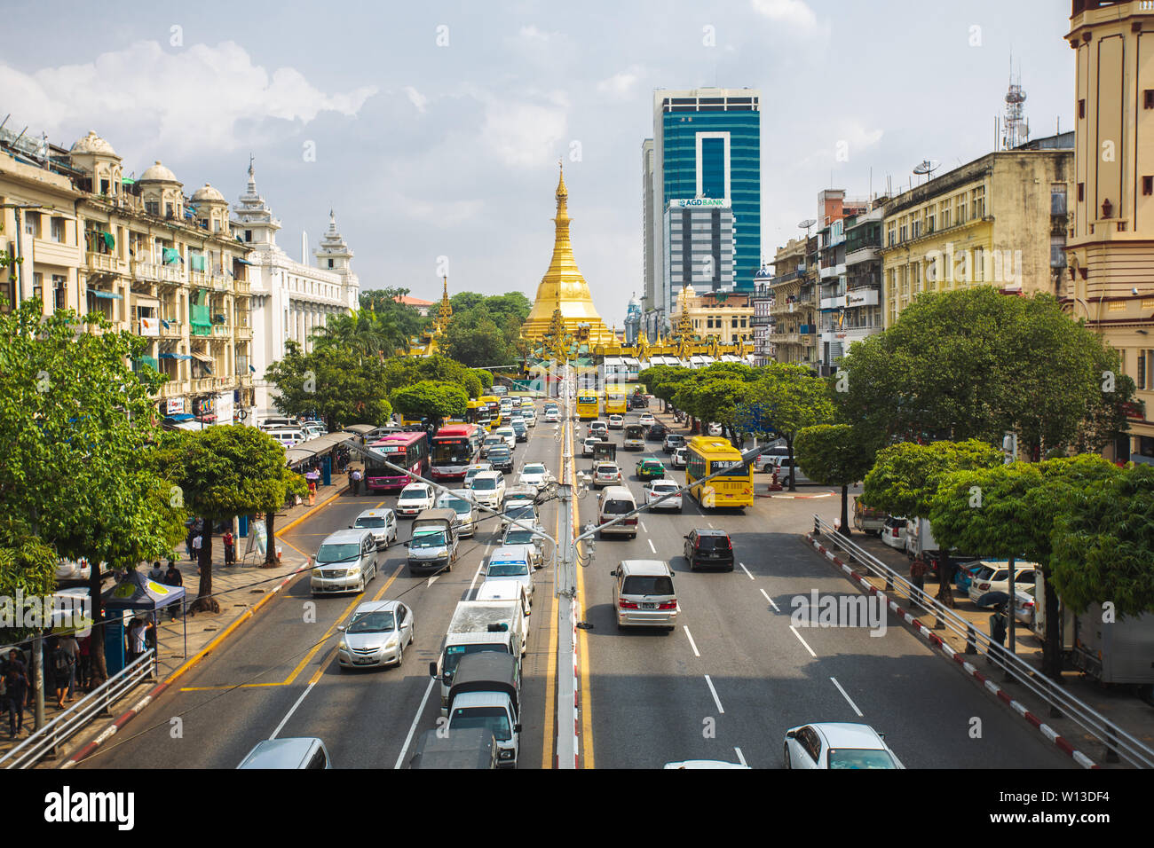View on the Yangon city downtown with traffic and golden stupa of Sule Pagoda. Sula Pagoda is Landmark od Yangon and Burma. Stock Photo
