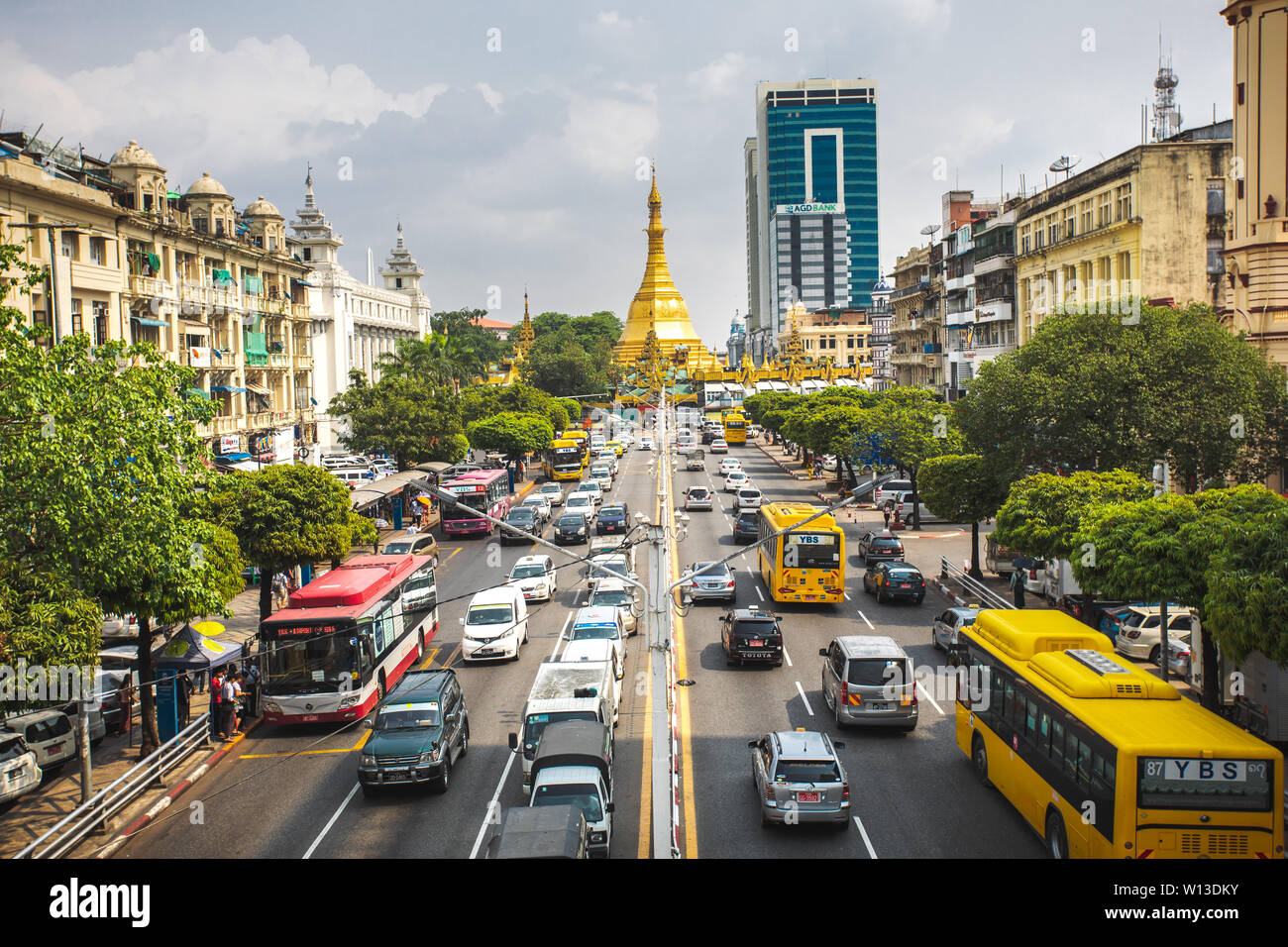 View on the Yangon city downtown with traffic and golden stupa of Sule Pagoda. Sula Pagoda is Landmark od Yangon and Burma. Stock Photo