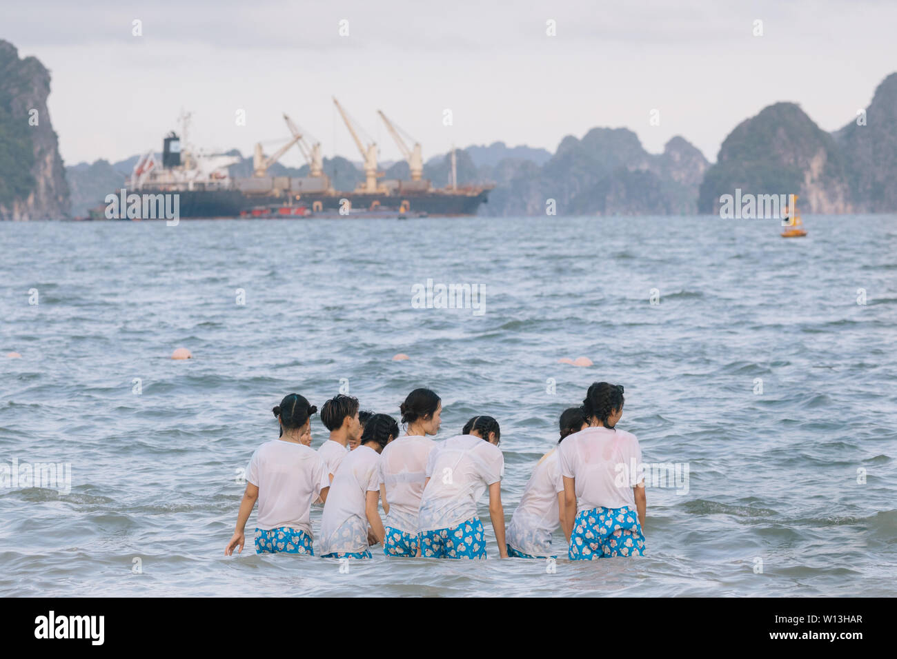 Group of girls in the same clothes at the beach in Ha Long Bay, Vietnam. Stock Photo
