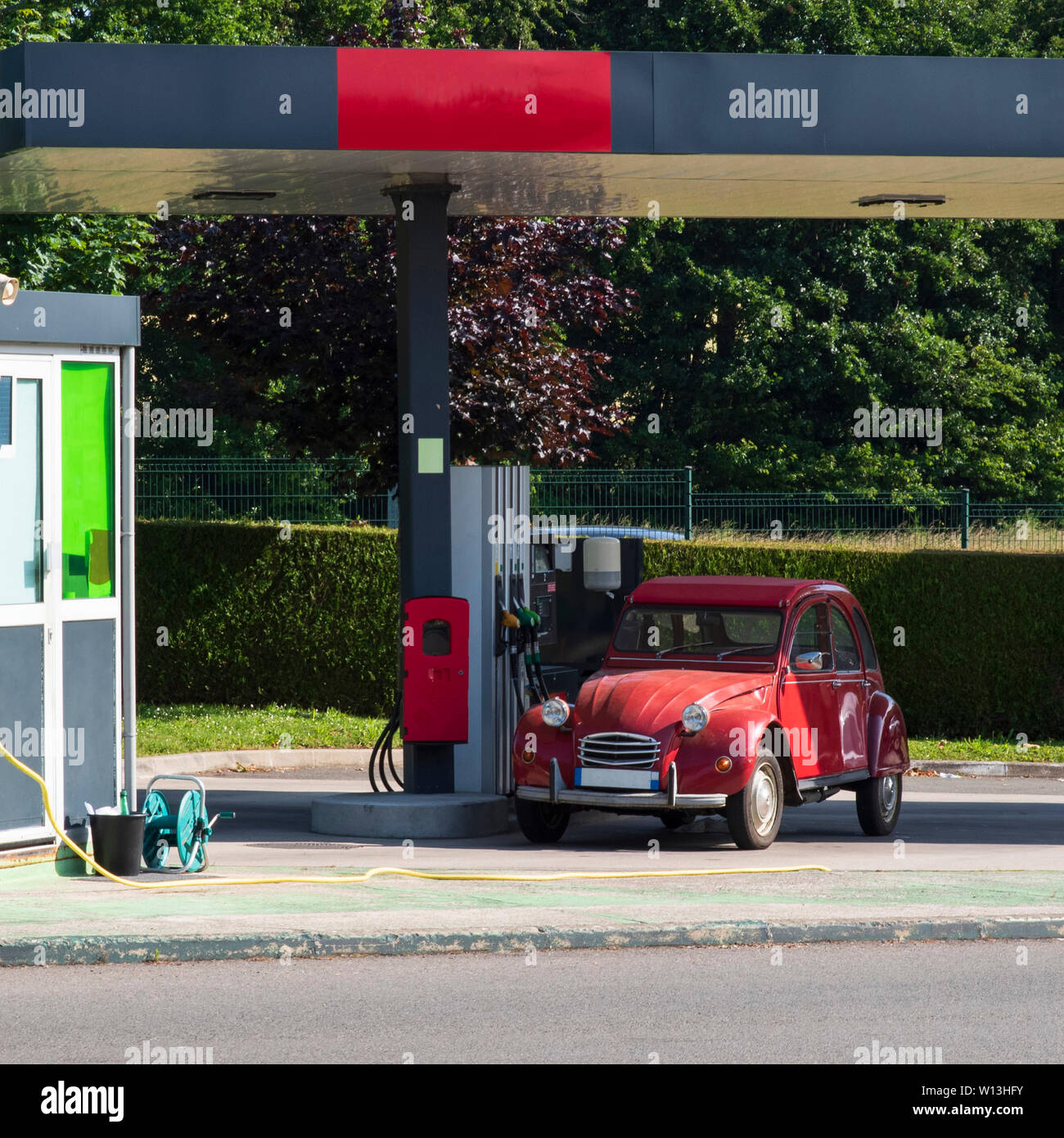 A car stopped at a gas station to pick up gas Stock Photo Alamy