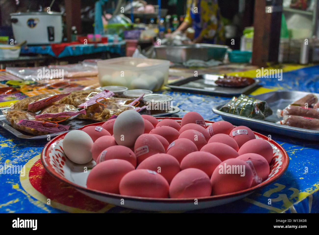 Pink eggs on sale on a street food stall in Bangkok, Thailand Stock Photo