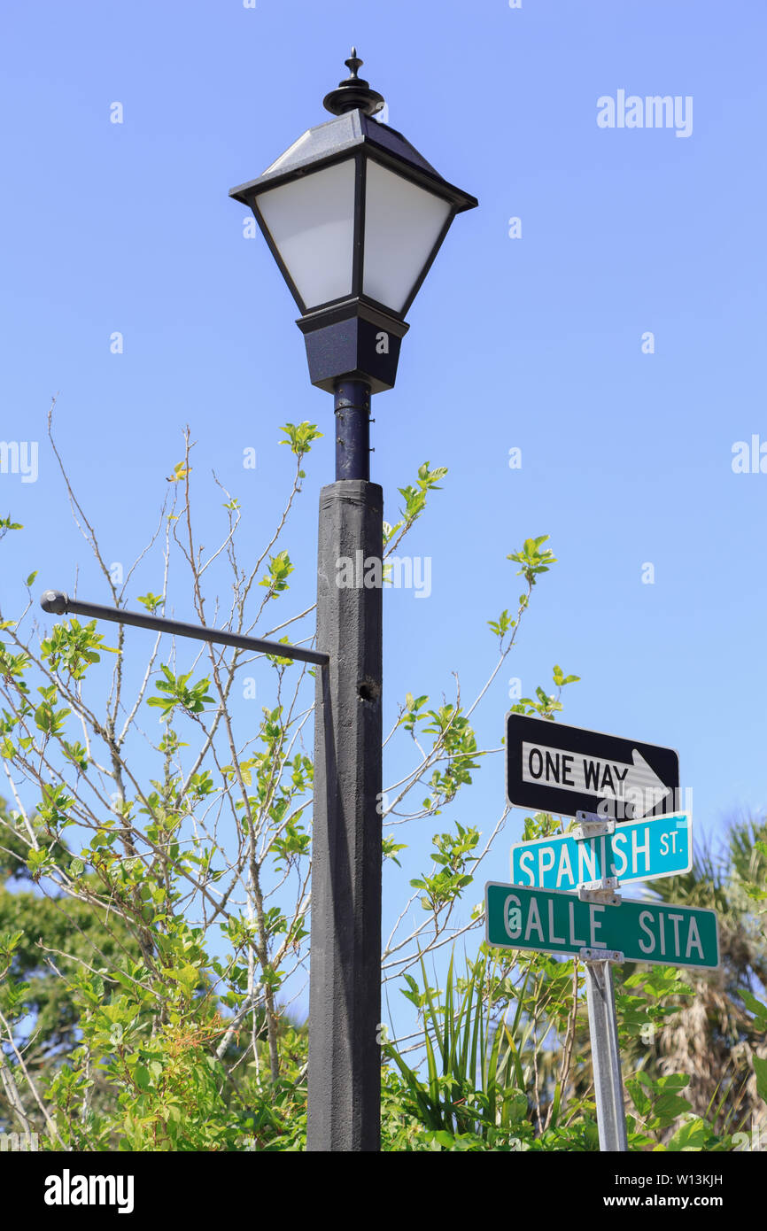 The street light and signs hold a reminiscence of the past Spanish influence of the region in St.  Augustine, Florida, USA. Stock Photo